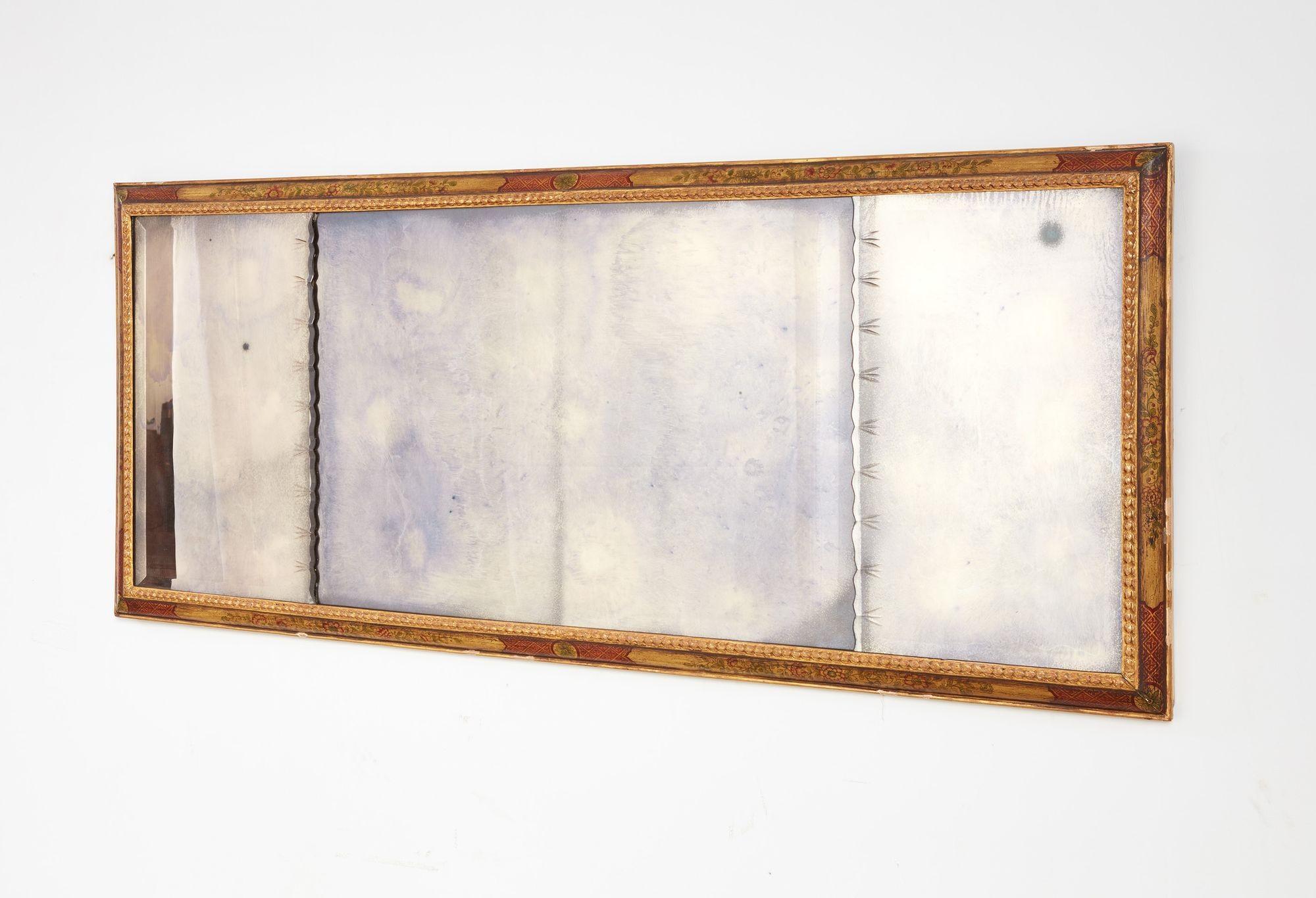 A fine 18th century Queen Anne period English overmantel mirror, the early but later glass plate with scalloped beveled edges and cut notching, within a cushion molded and polychrome decorated chinoiserie frame with carved and gilt lining. 