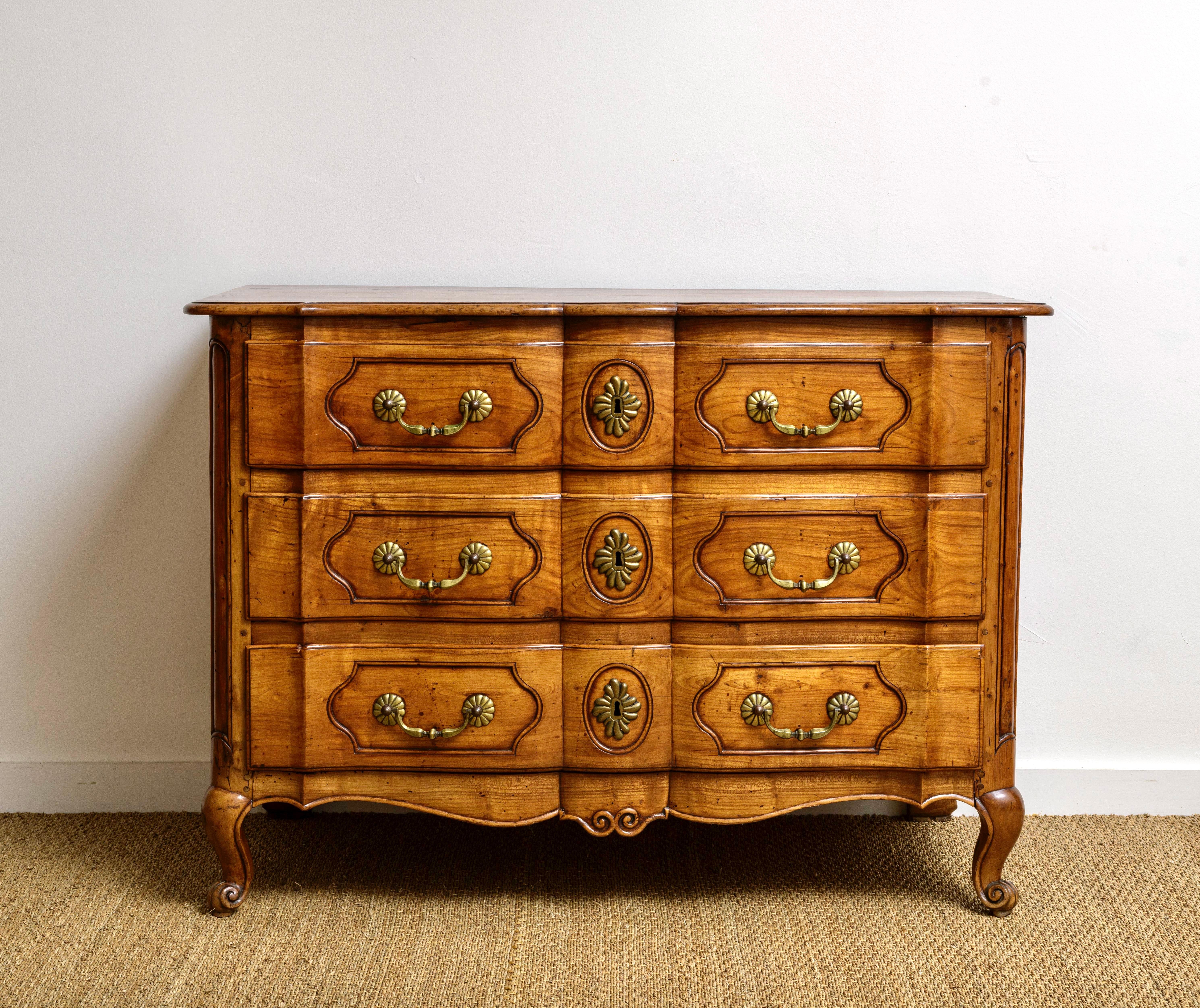 Exceptional carved French Régence walnut commode.   Has original hardware and a wonderful patina.  Carved drawers and frame,  ending in scroll feet both front and back.  Sides have a fantastic 