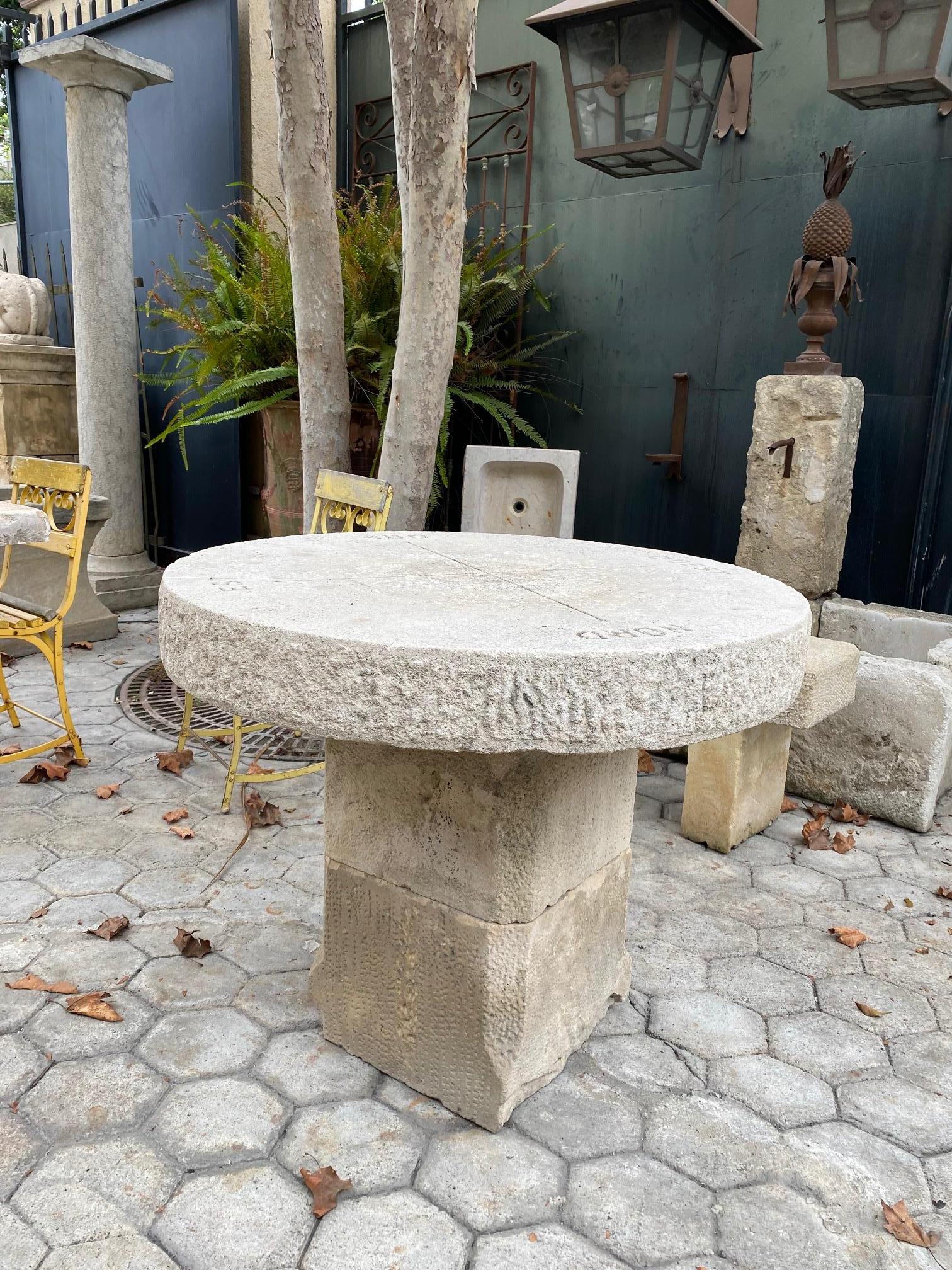 18th century hand carved round stone antique garden patio coffee outdoor indoor table for two or four with an earlier Gothic stone pedestal base. It will be the perfect touch by an outdoor fireplace or on the patio next to your bedroom to have the