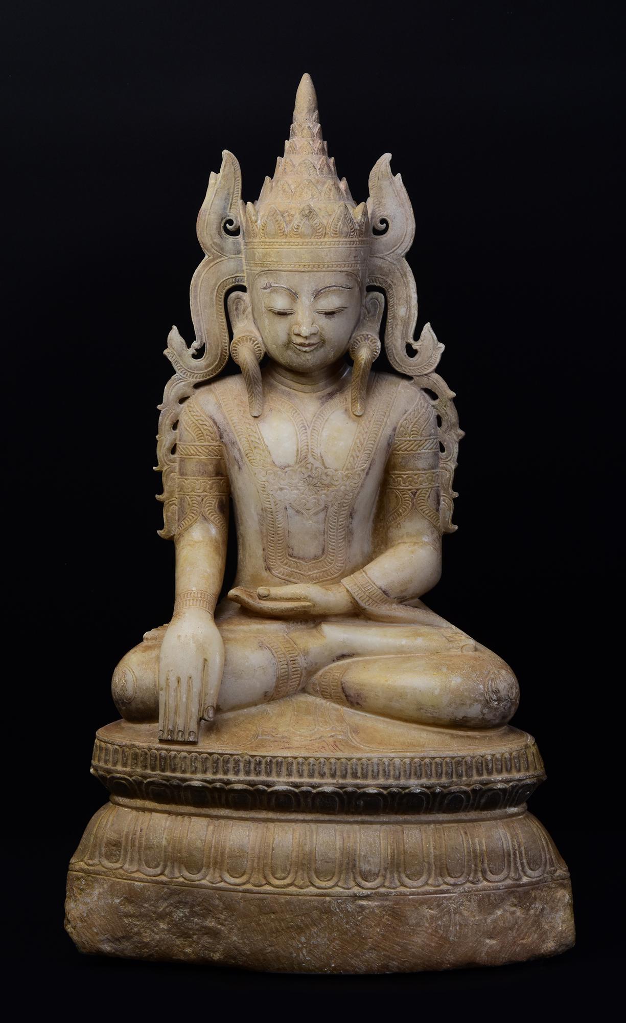 Antique Burmese alabaster seated crowned Buddha, or sometimes known as 'King Buddha', wearing diadem-crowns and ornaments of kings instead of ordinary monk's robes.

Crowned Buddha represents the Buddha's role as a universal sovereign.

Age: Burma,