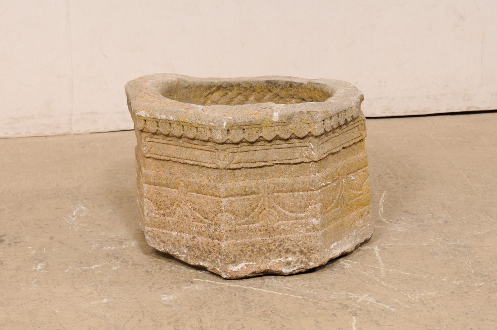 A Spanish hand-carved stone wellhead (would make a great planter!) from the 18th century. This antique well cover from Spain has been hand-carved of stone, mostly circular in shape, with various decorative patterning etched throughout its exterior.