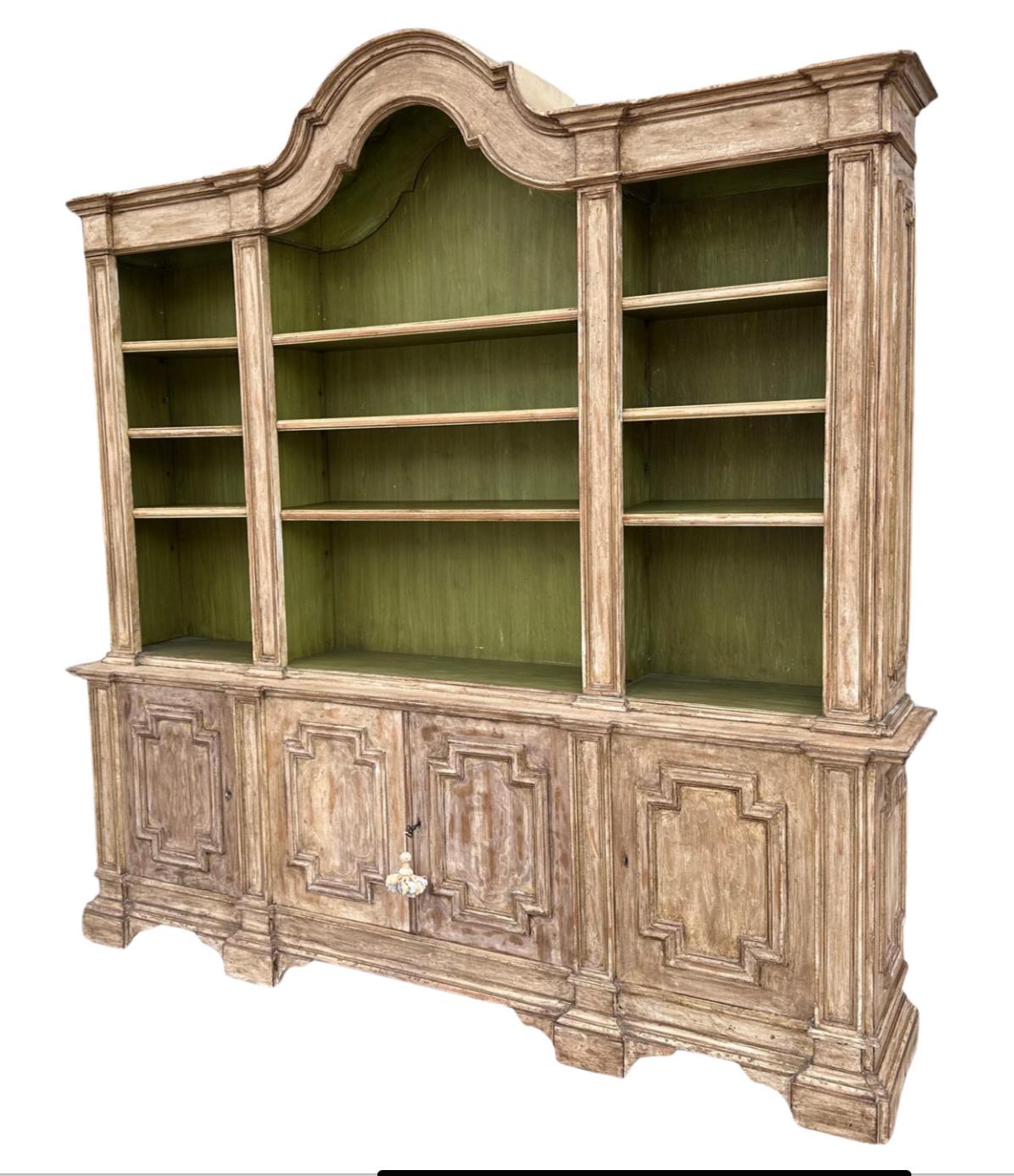 18th C Style Italian Paint Decorated Breakfront Bookcase Cabinet . It is beautifully hand carved and hand painted featuring four lower doors and four shelves.
