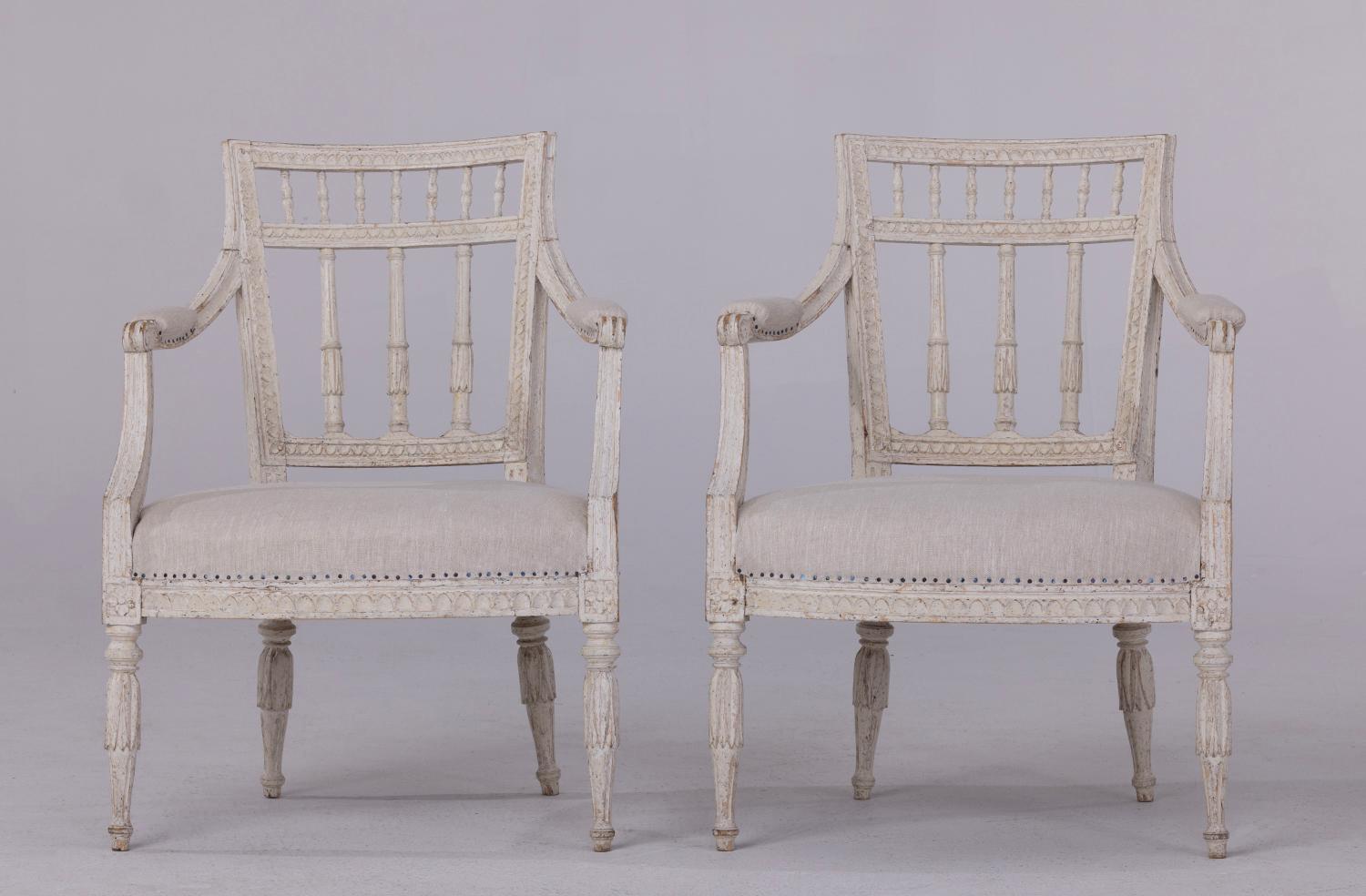 A pair of Gustavian period armchairs with provenance, signed by master craftsman, Johan Erik Höglander, Stockholm 1777-1813. Considered to be one of Sweden's best chair makers during the 18th century. These beautiful chairs have been hand-scraped to