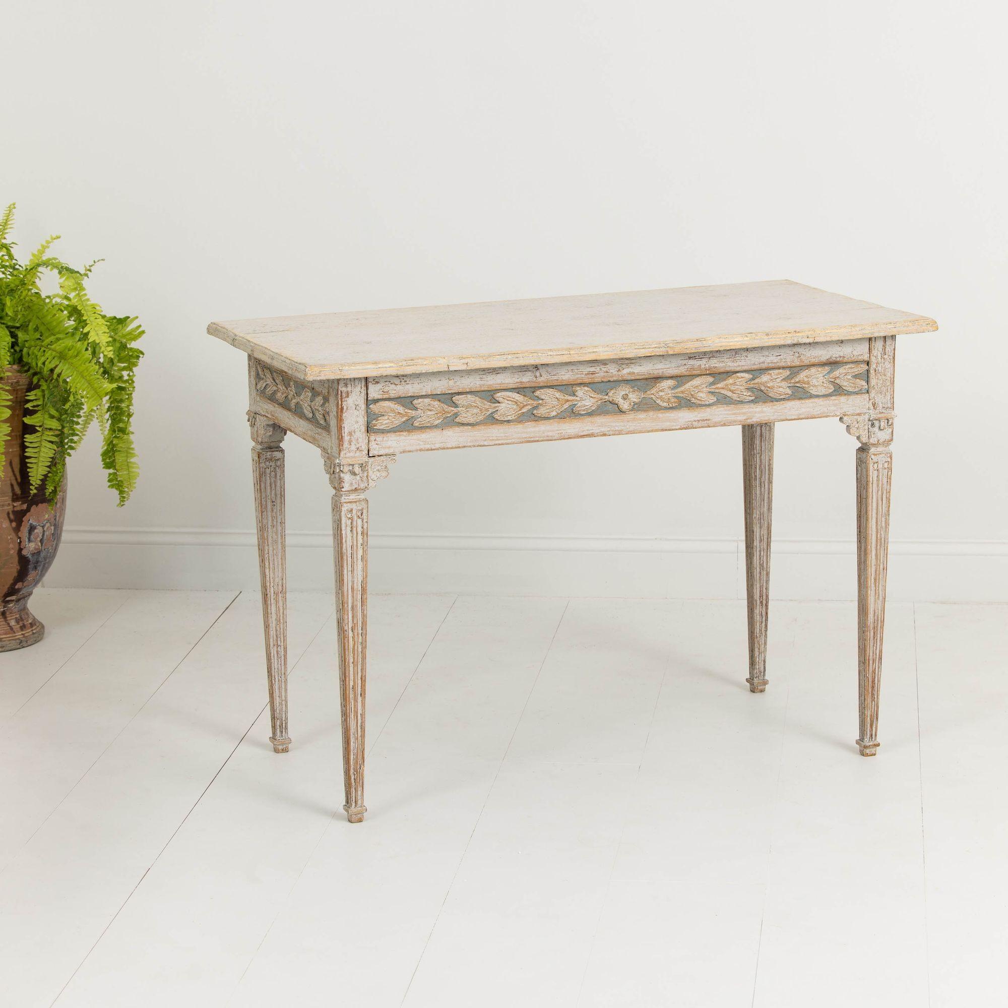 A beautiful console table from the Gustavian period finished on all four sides with bell flowers around the apron, raised upon square, fluted legs. Circa 1780.