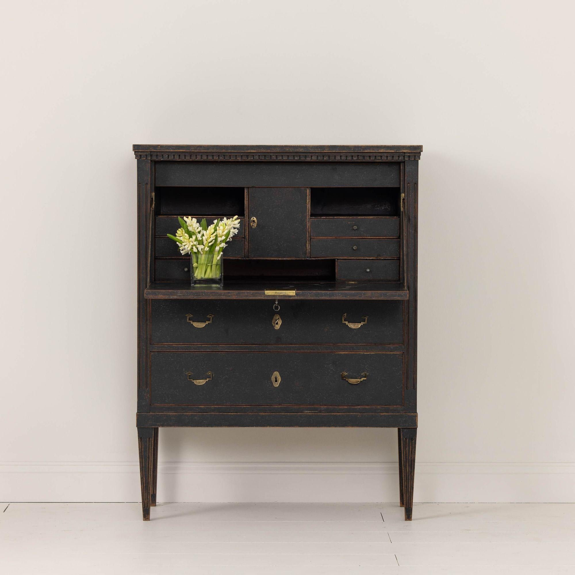 An 18th century Swedish fall-front bureau from the Gustavian period wearing beautiful black paint, circa 1790. Original brass hardware and locks. This secretary displays neoclassical carving such as the dentil molding detail around the top. There
