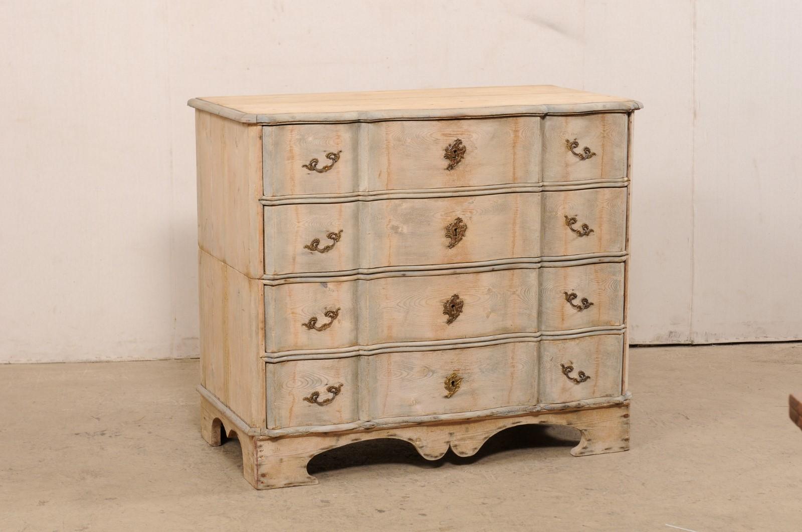 A Swedish period Rococo fir wood chest of four drawers from the 18th century. This antique chest-on-chest from Sweden consists of two casement pieces, one stacking atop the other, which combined house a total of four dove-tailed drawers. The chest