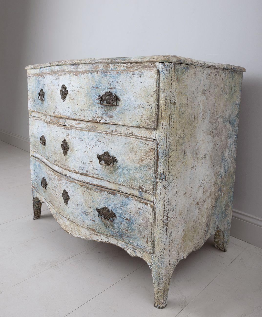 This is a beautiful Swedish commode from the Rococo period, circa 1760 in original scraped paint with original bronze hardware.  The commode has a serpentine front, shaped top, and scalloped apron. There are three spacious drawers with plenty of