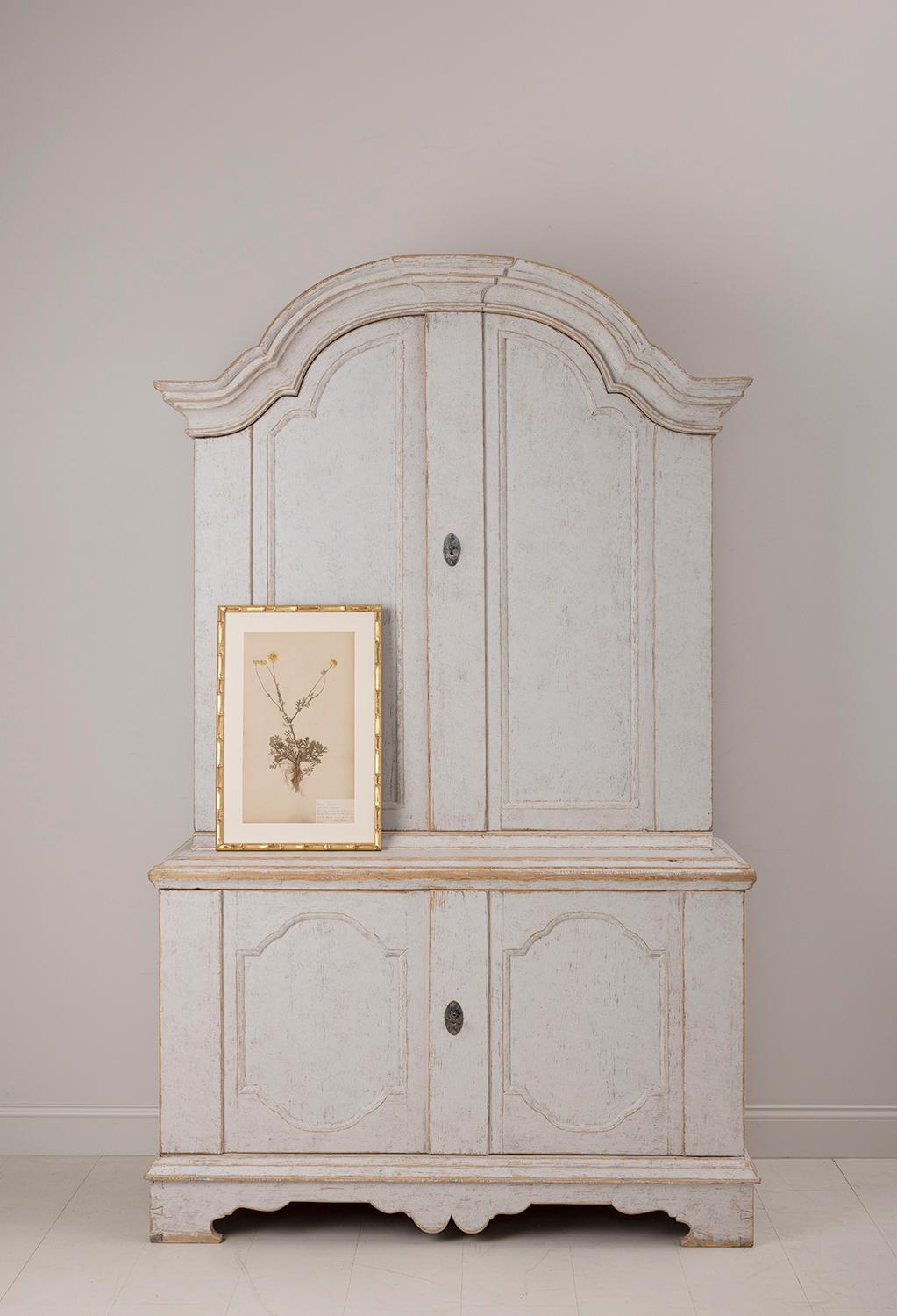 An 18th century two-part Swedish linen press or armoire from the Rococo period. Provenance on the inside doors dates piece to 1796 and 1826. This period Rococo marriage cabinet is from Värmland and is known as a 