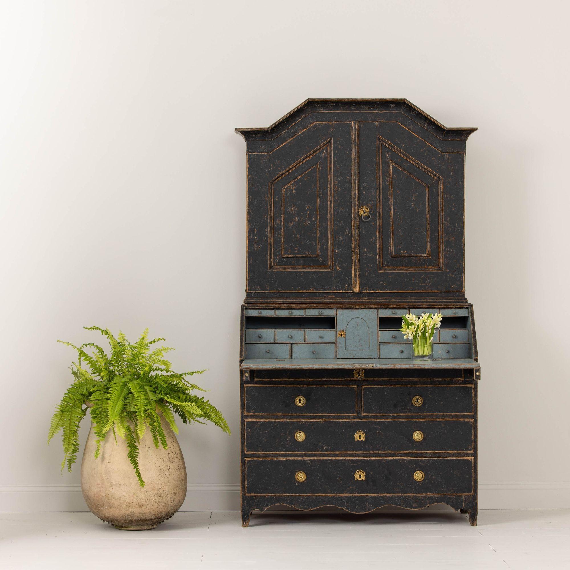This is an exceptional Swedish secretary with library, circa 1780. This secretary has retained its original brass hardware and locks and is wearing black paint on the exterior with beautiful blue paint on the interior. The upper section has three
