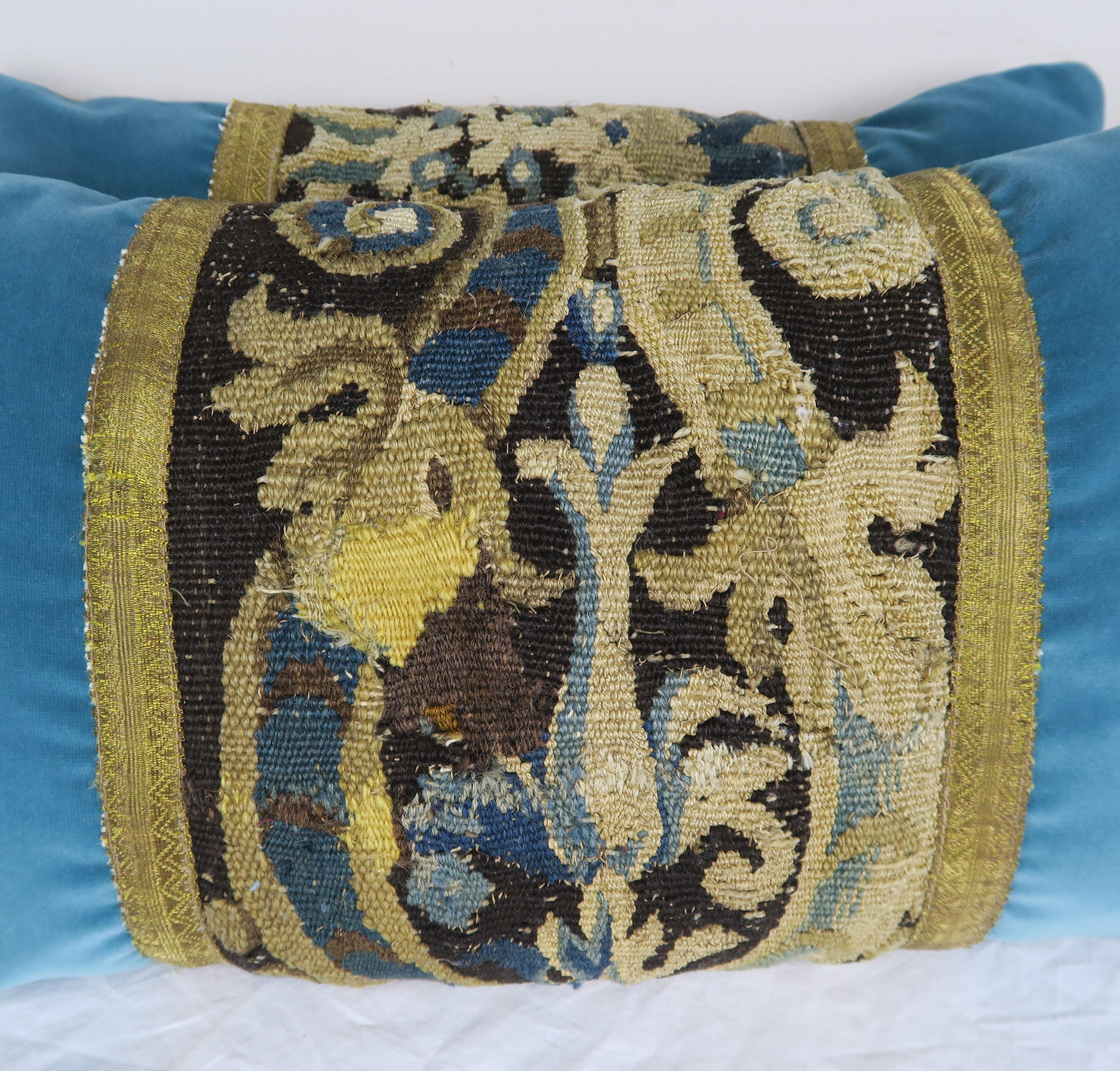 Pair of custom pillows designed with 18th century tapestry remnants in beautiful shades of blue, cream, gold on a chocolate brown background. The tapestry remnants are combined with 19th century. Metallic tape and contemporary blue cotton velvet and