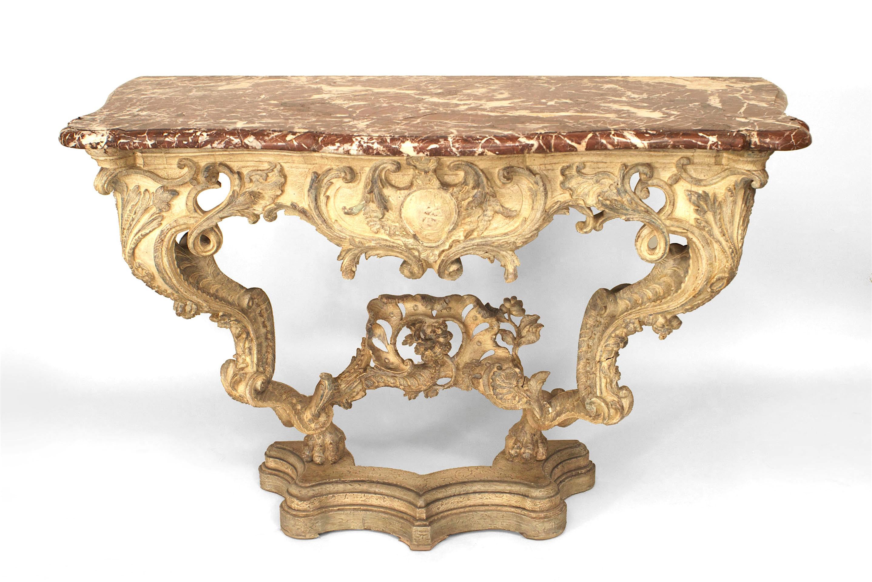 Italian Venetian (18th Century) cream painted bracket console table with carved & painted floral trim with a shaped filigree apron & stretcher under a brown marble top. (modern base)
