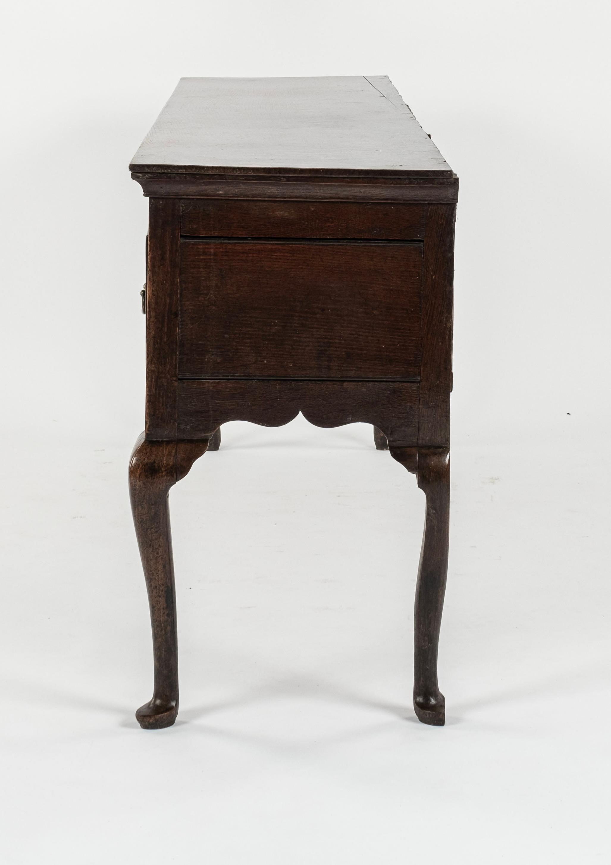 18th Century French walnut commode with a nice finish. Having moulded, ebonised panels to the sides and drawers giving it a contemporary feel. With large, drop bar handles and shield shaped escutcheons on the two long drawers and supported by square