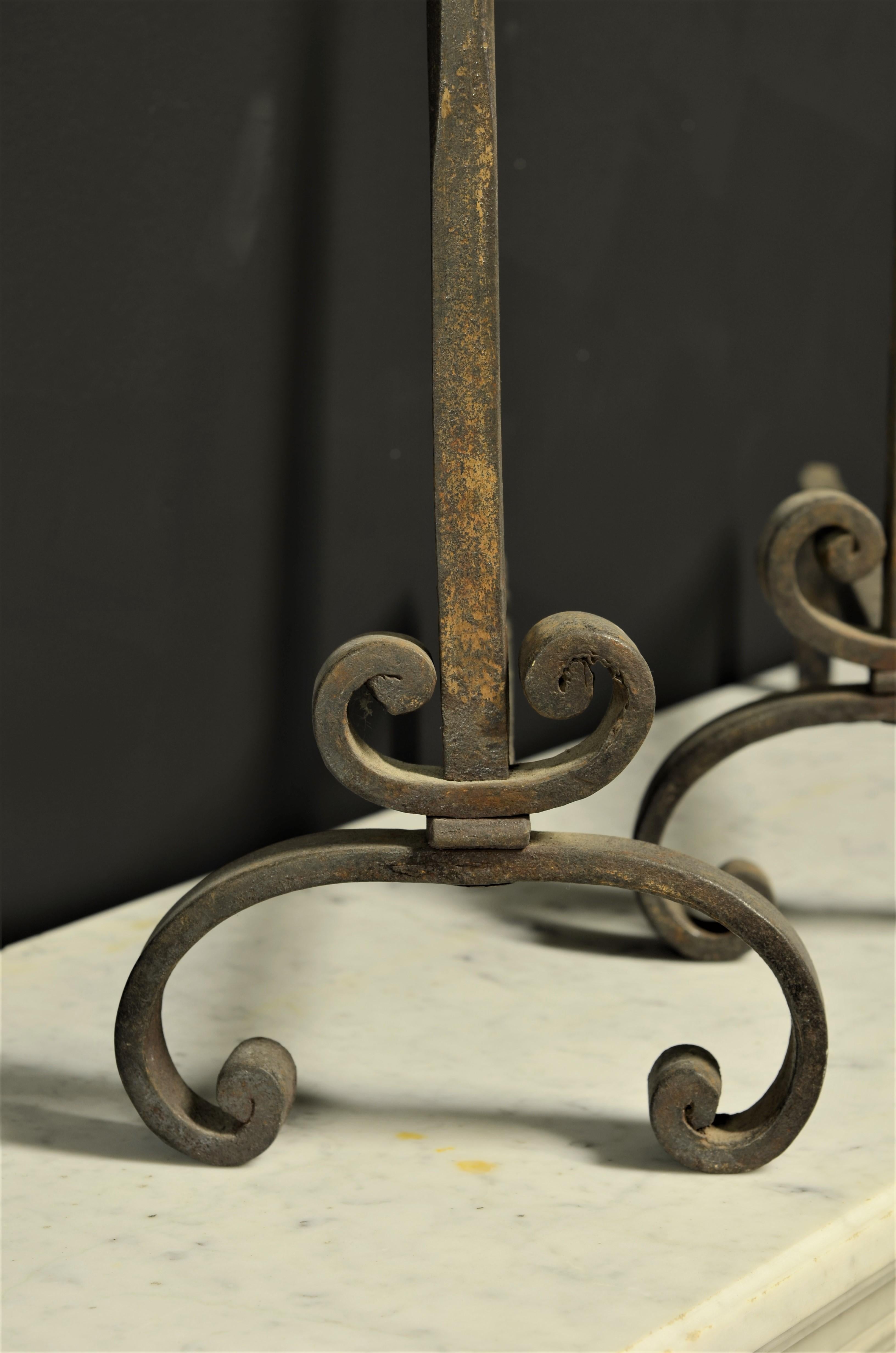 A great set of early 18th century French wrought iron andirons.
The beautifully forged details and original patina makes these andirons or firedogs truly stand out.

Great usable dimensions, back stand bars have been replaced.
Our vast collection of