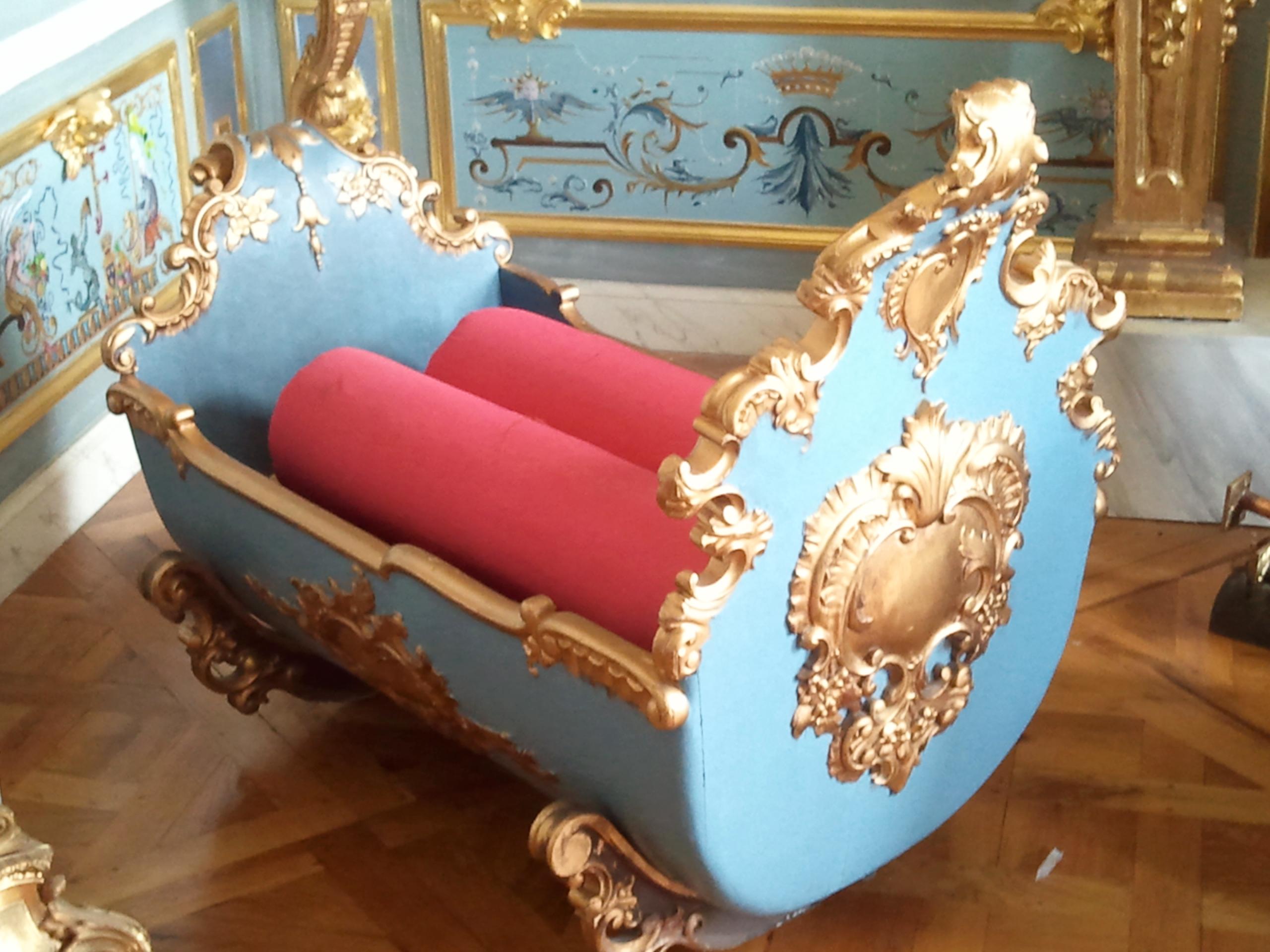 Louis XV rocking cradle, circa 1750 fit for a Prince. It was created with two ornate Rococo U shaped sculpted wood chassis which create the smooth rocking of the cradle. It is all wood and is absolutely functional. It is polychromed in French blue.