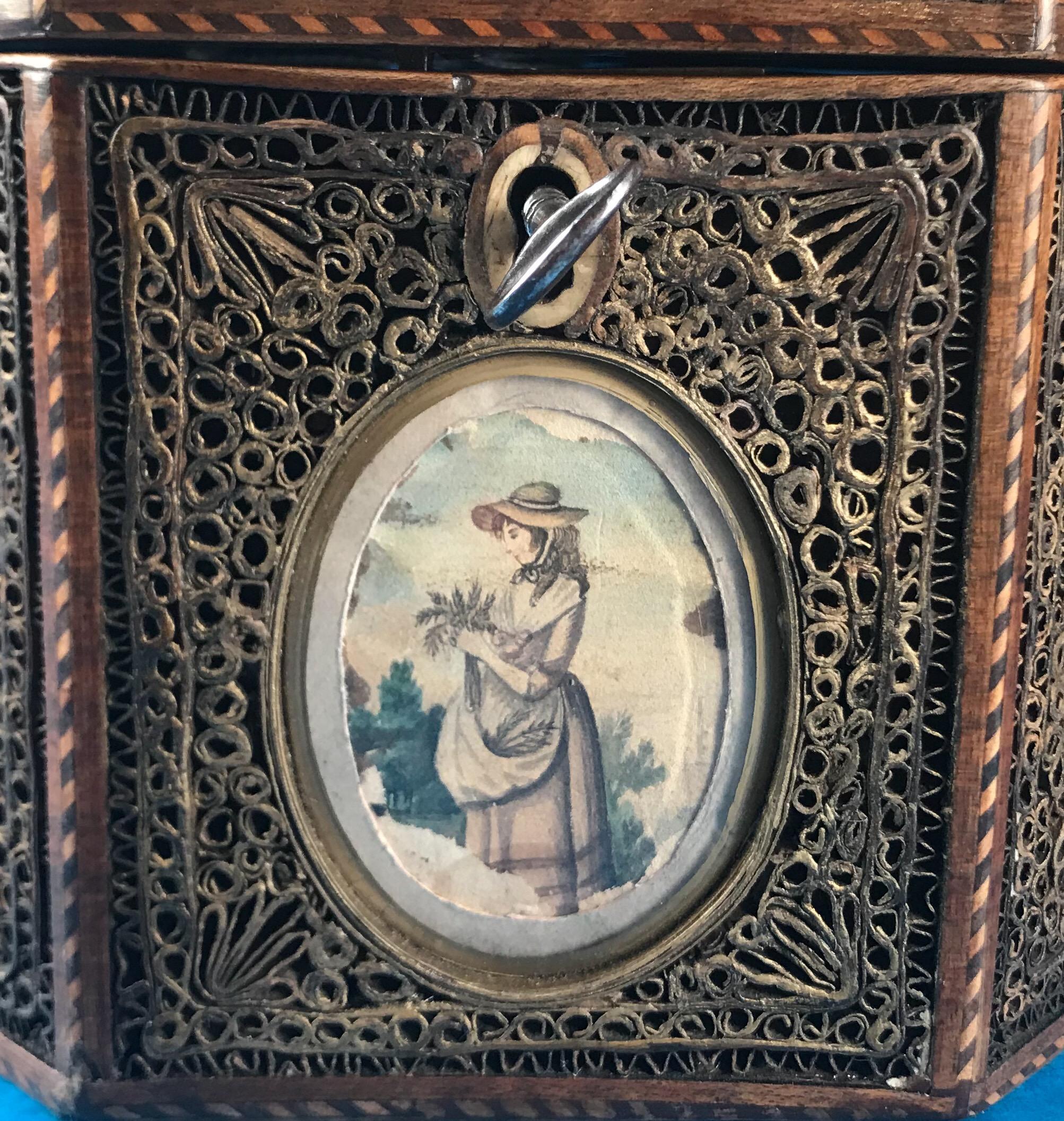 A rare 18th century 1785 rolled paper inlaid tea caddy in superb original condition, it’s boxwood and ebony inlaid around the edge of the box, it has a bevelled oval picture to the front of a girl holding a basket of flowers, on the other side it