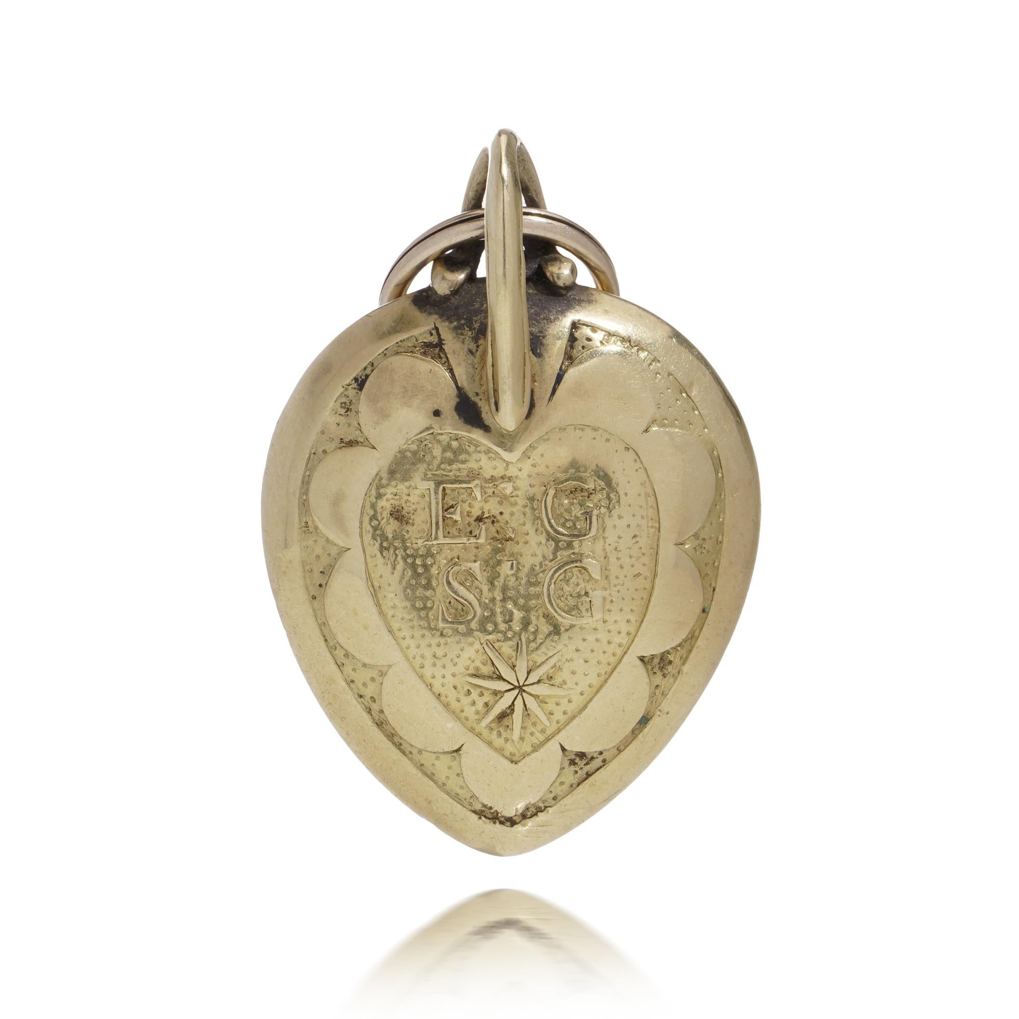 This is an exquisite Stuart Crystal memorial locket from the 17th and early 18th century. Crafted in 18kt yellow gold, this mourning pendant features a rock crystal center adorned with intricately woven hair. On the reverse side of the gold casing,