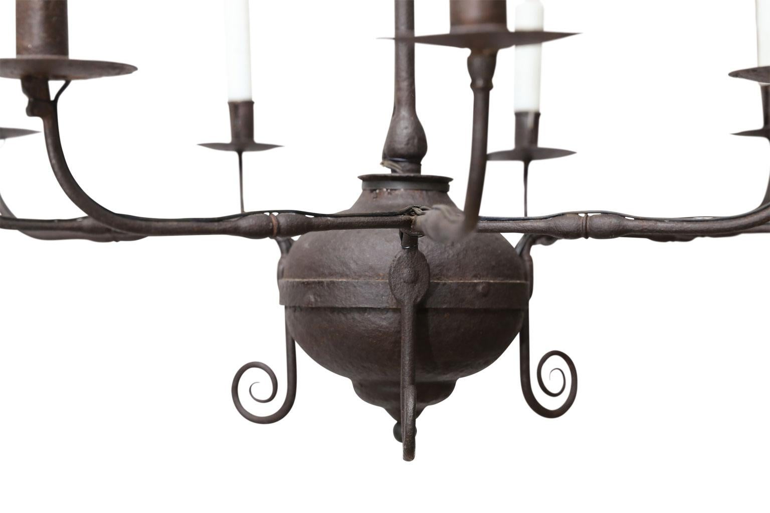 18th century American chandelier with nine arms. All hand forged and riveted iron - no welds. Extremely nice brownish-charcoal gray patina. Minor modifications to accommodate new electrical wiring for light. Newly wired for use within the USA.