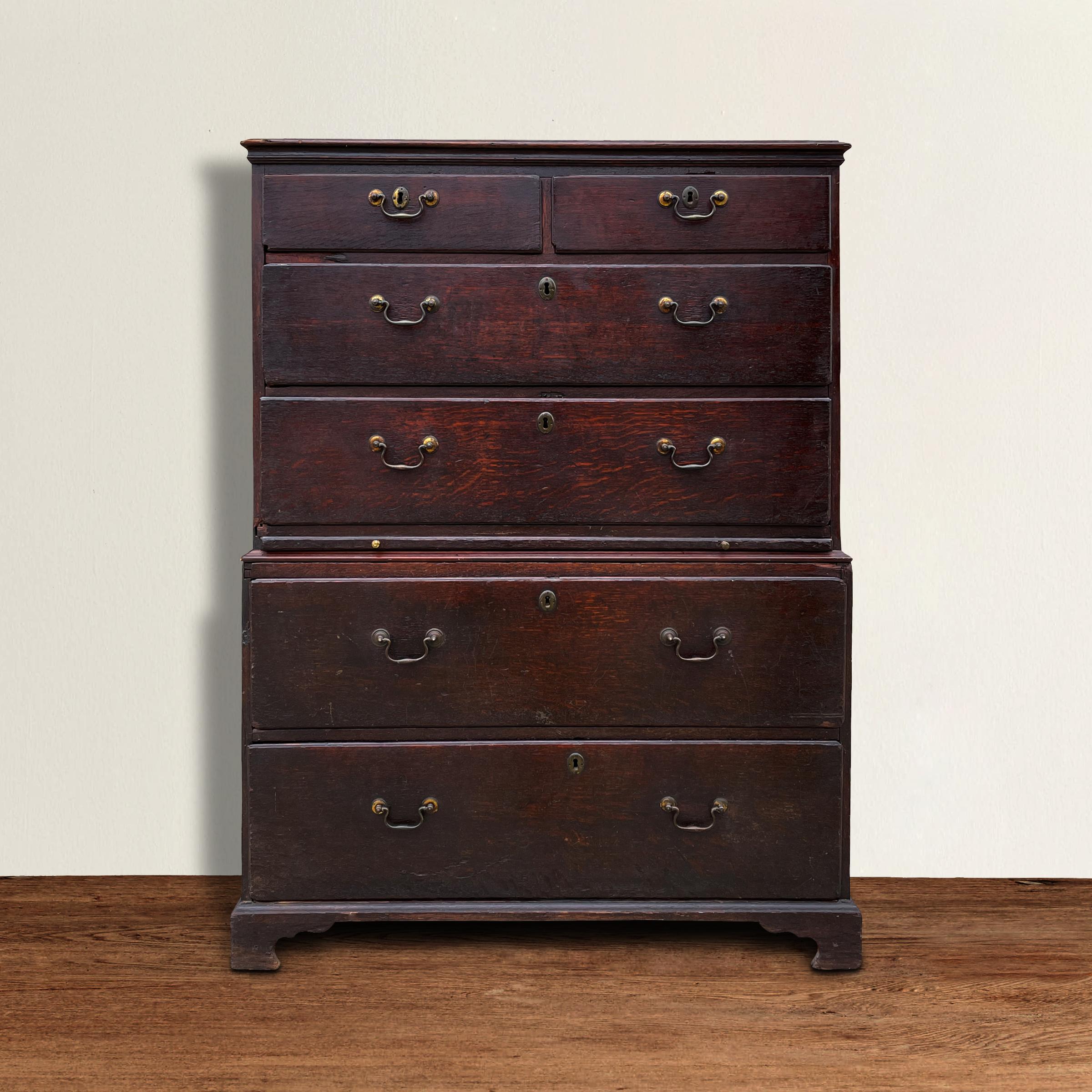 A fantastic late 18th century American oak chest on chest with six drawers each with pine secondary wood, brass pulls, and a wonderful overall rich dark sangre-de-boeuf finish with a patina only two hundred years of use can bestow. Perfect as a