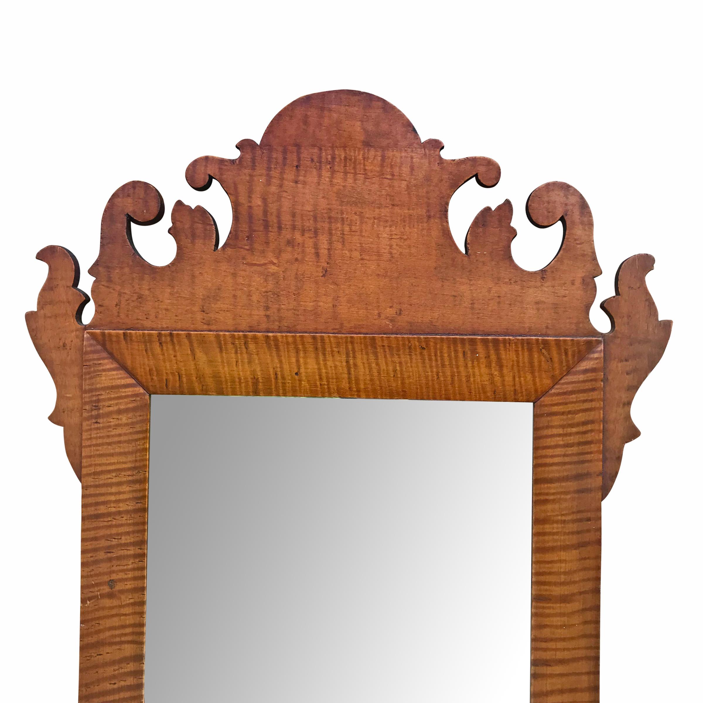 18th century American Chippendale curly or tiger maple framed mirror with wonderfully scrolled carvings.