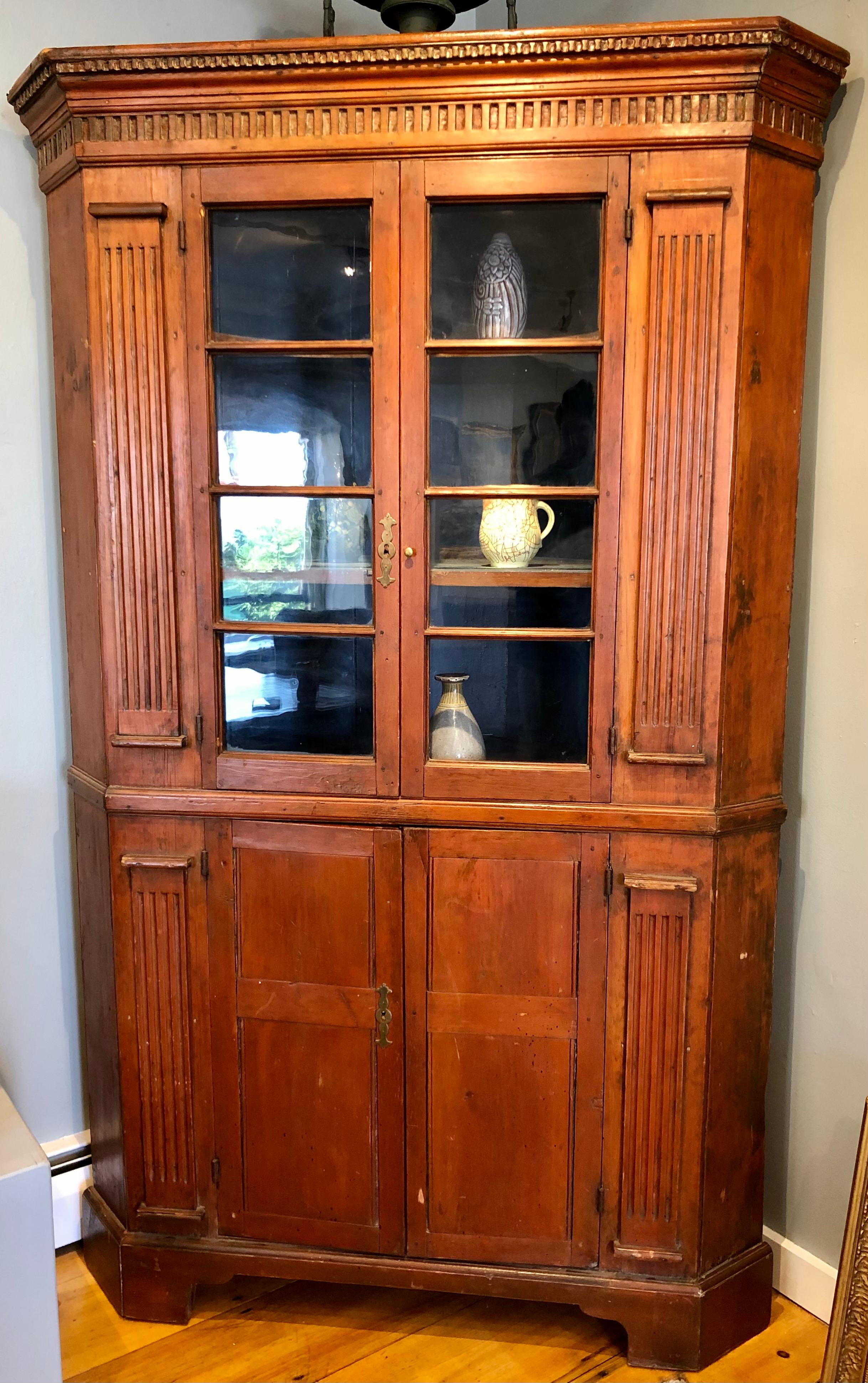 Late 18th century with fluted columns, rose head nails, and carved frieze. Pine back boards and either pine or cherry front. New England, most likely New Jersey or Pennsylvania. A very sturdy piece in. great condition for its age.