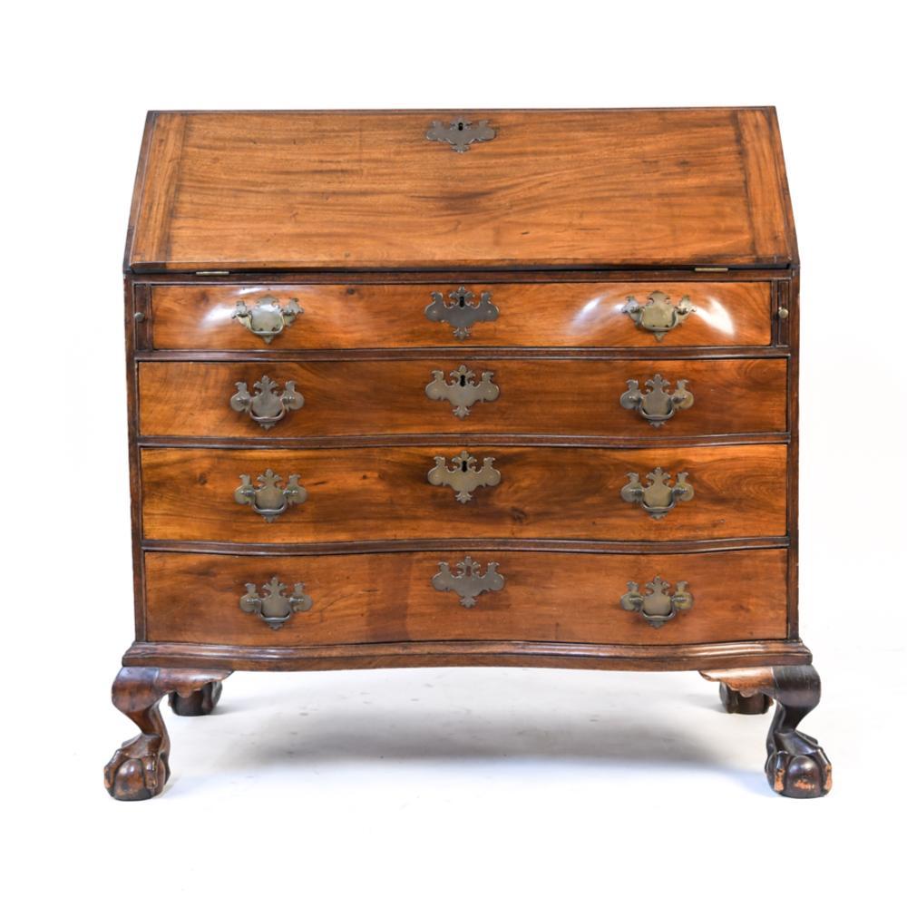 Period late 18th century American slant front or lid desk. Good wood figuring. Ball and claw feet. Original interior. Serpentine form. Boston.