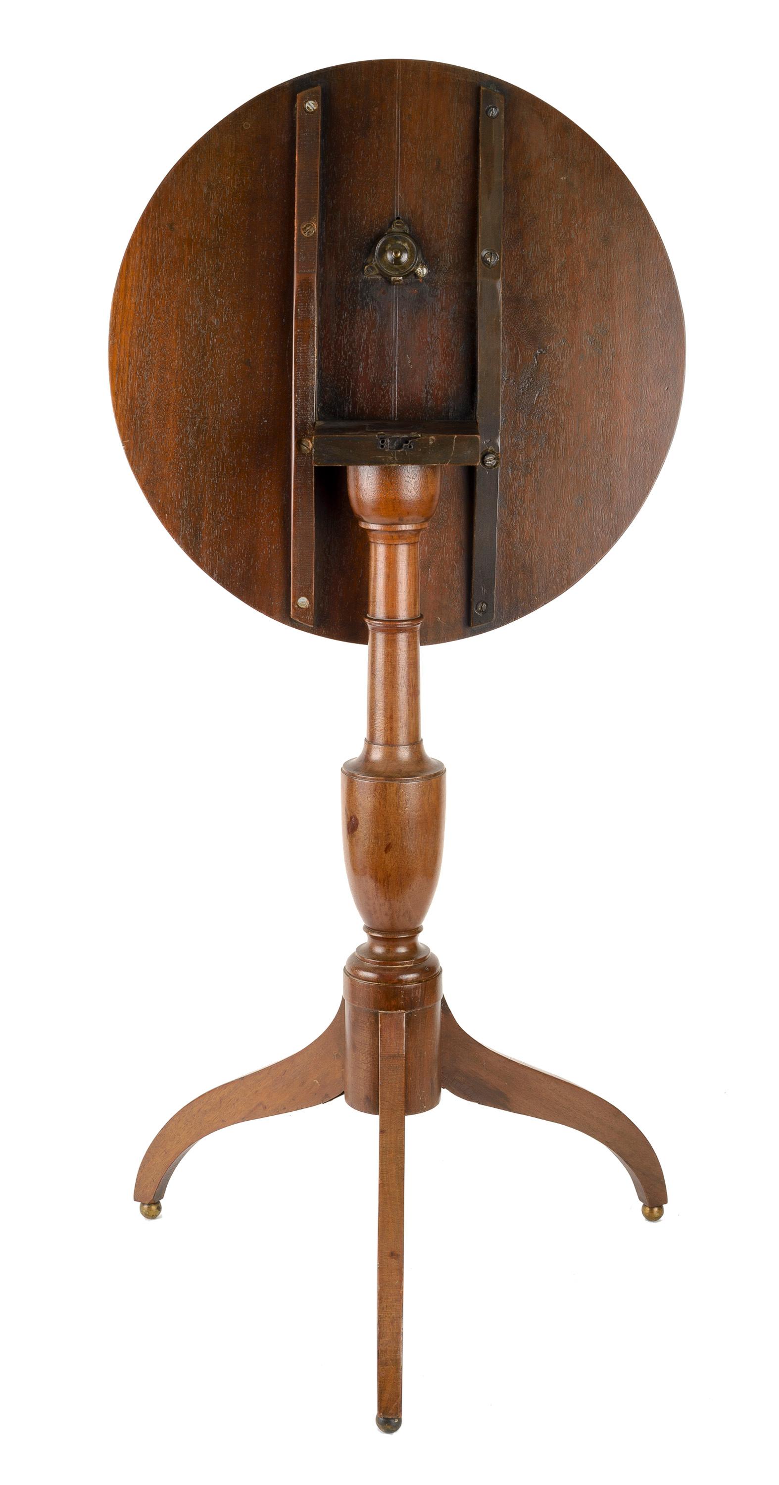 American cherry wood round tilt top table with turned urn shape base on three arched legs resting on ball foot. The hardware is original and has a lock feature.
Note: When table top is up the overall H is 40'.