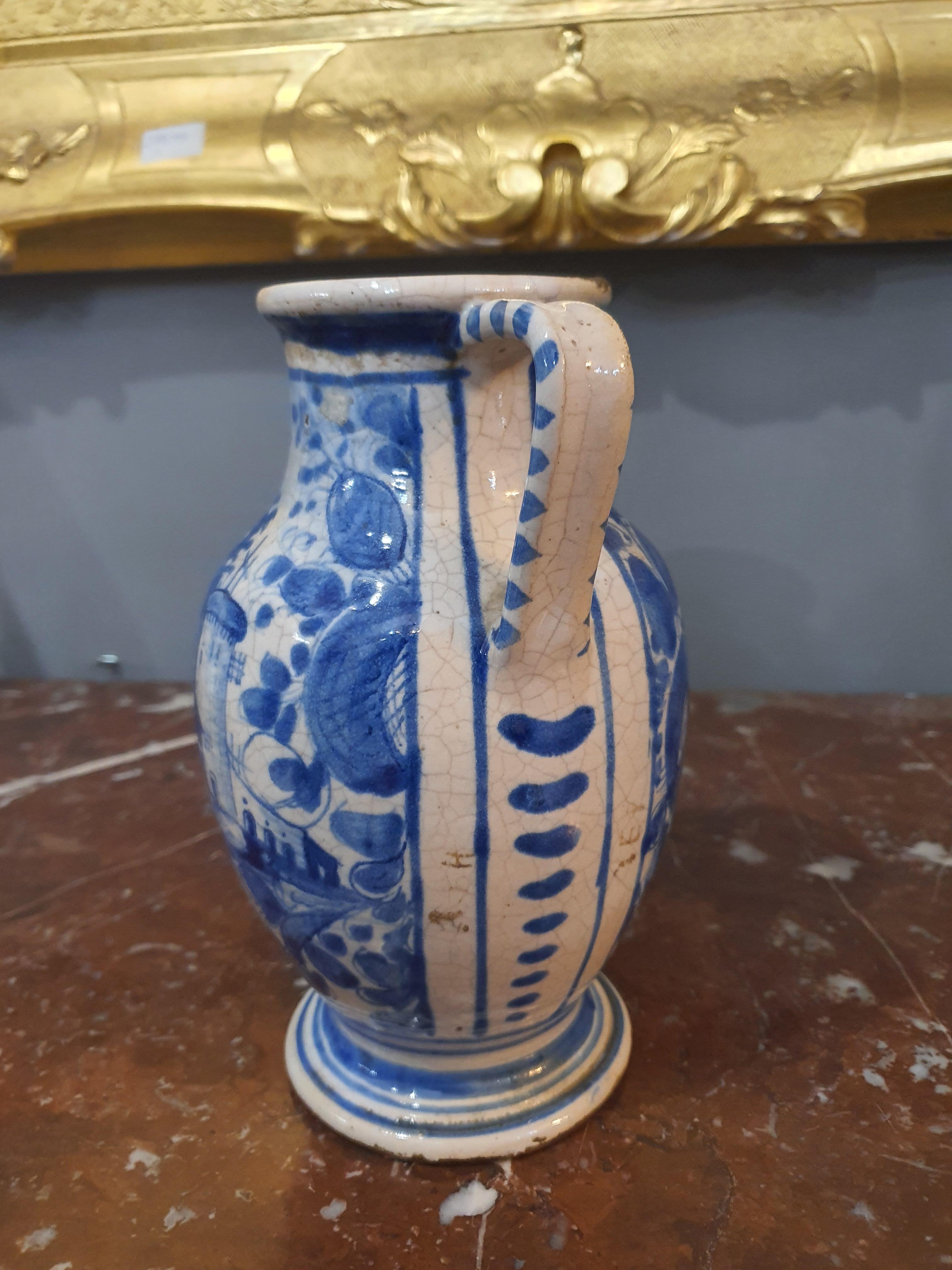 Pharmacy jug. Faenza, Italy. Majolica painted in blue monochrome, on a blue enameled background called berettino and tints of tin white.