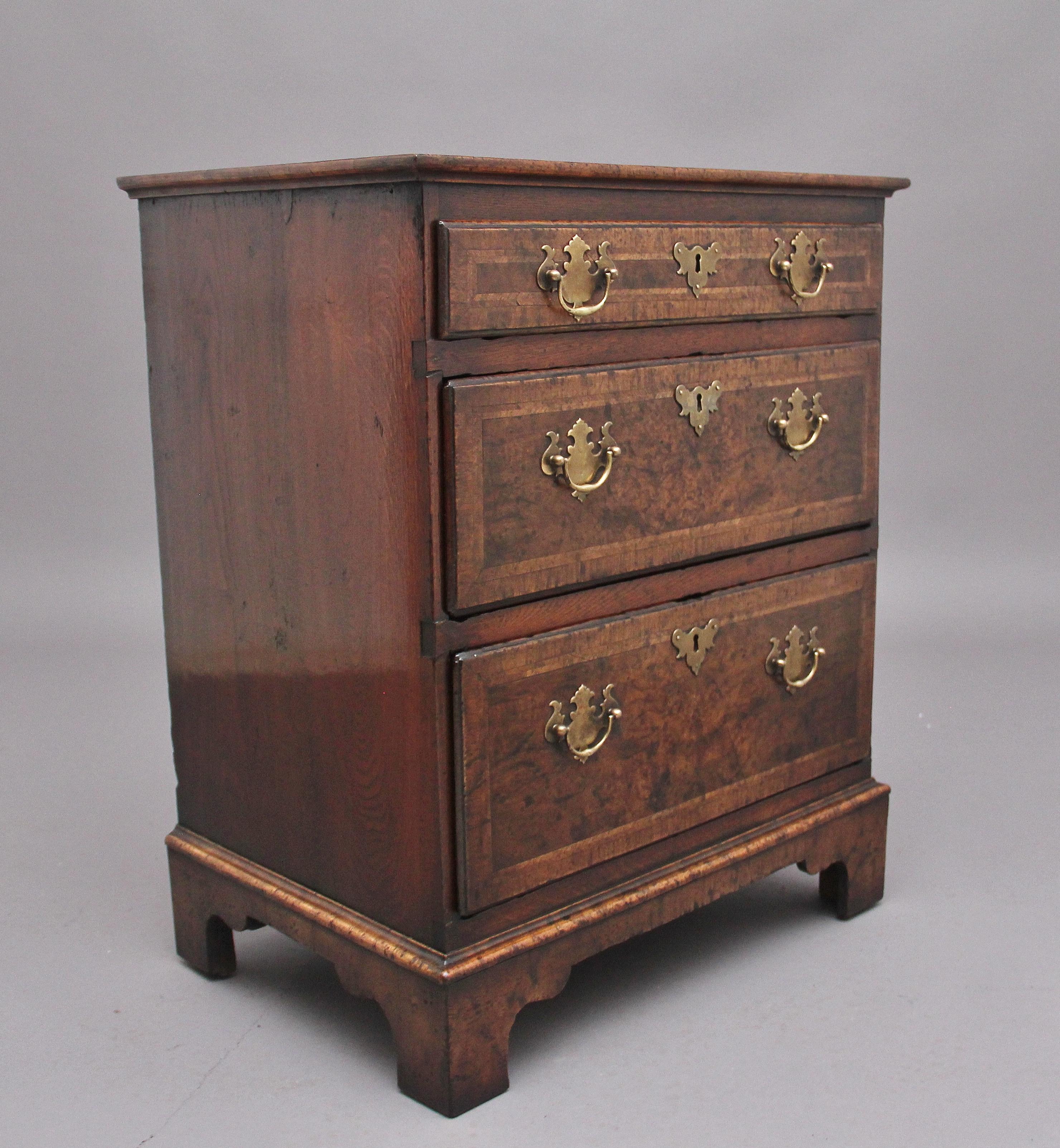 18th Century walnut chest of drawers which has been re- veneered in the early 20th Century, the crossbanded quarter veneered top above a selection of three long graduated drawers, with brass plate handles and escutcheons, the drawer fronts are also