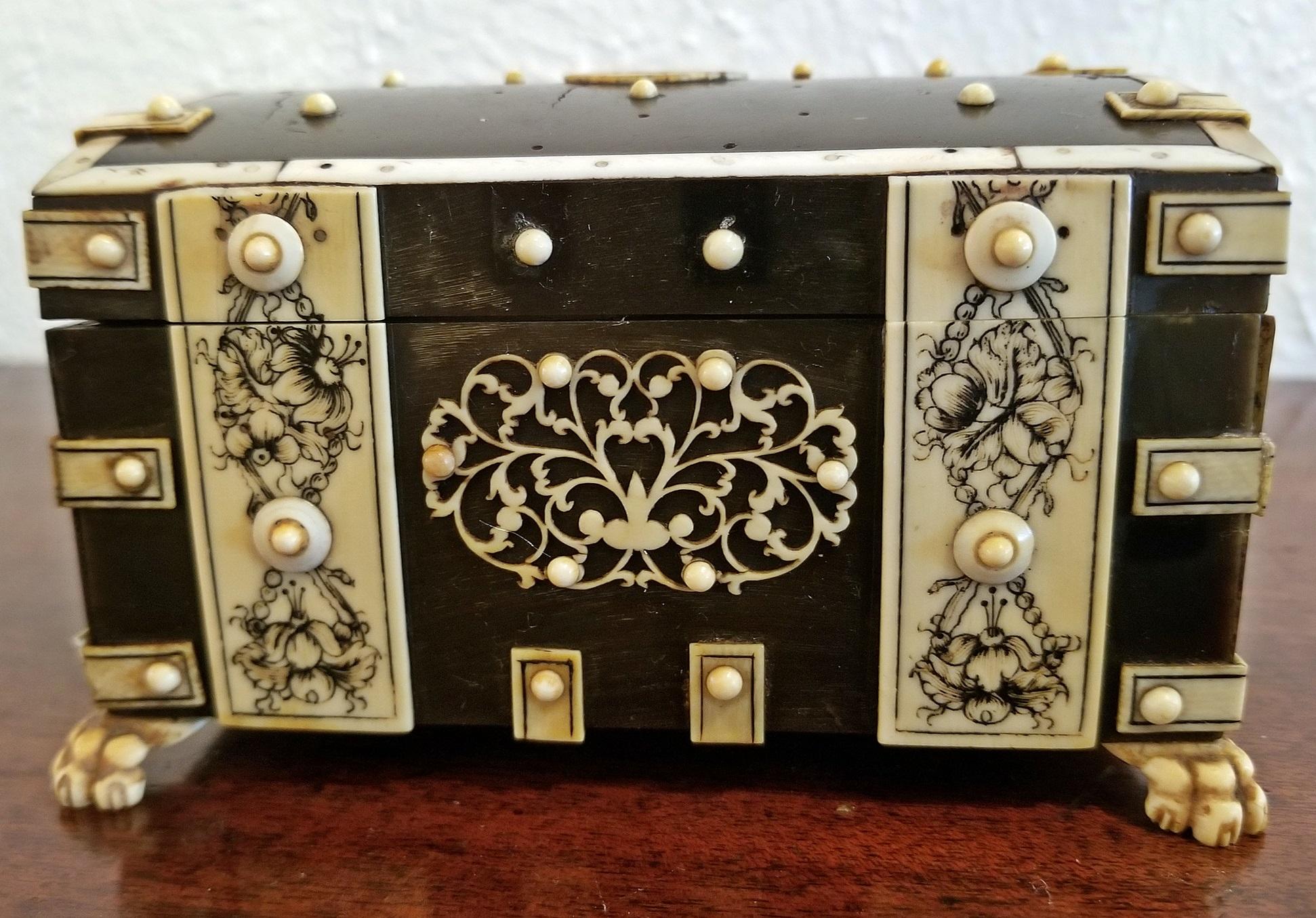Lovely little box of incredible quality.

Box made in Vizigapatam, India circa 1780.

Made of ebonized sandalwood and bone inlay and edging decorated with lac ink on lions paw feet.

Made to display a ladies pocket watch beautiful and