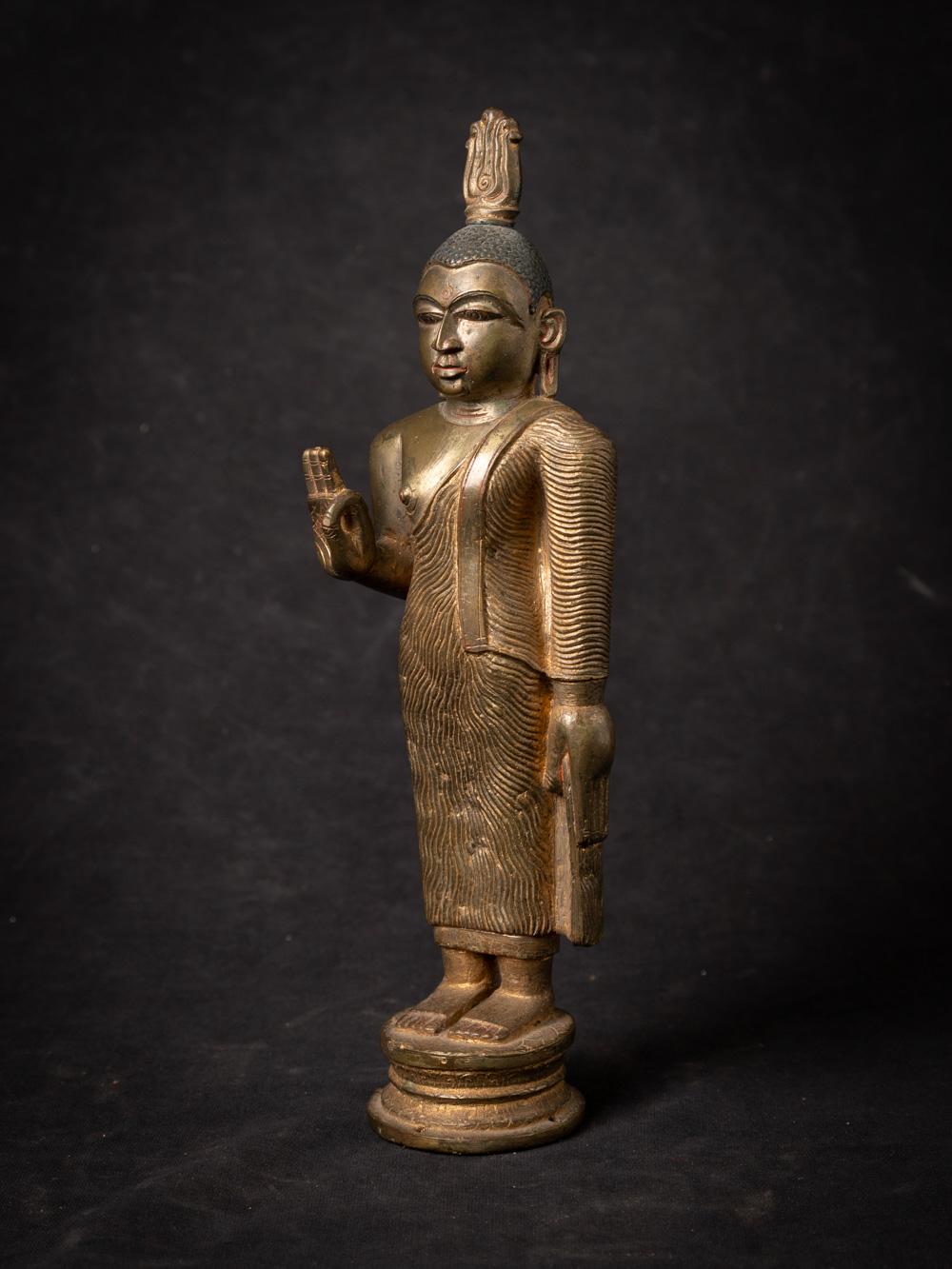 The antique bronze Buddha from Sri Lanka is a remarkable and spiritually significant artifact originating from the island nation. Crafted from bronze, this Buddha statue stands at 26.5 cm in height and measures 8 cm in width and 6 cm in depth. With