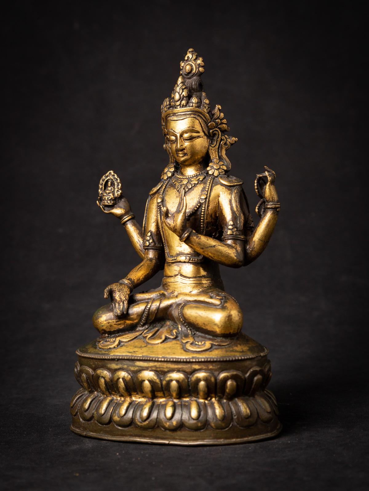 The antique bronze Tibetan Avalokiteshvara statue is a truly captivating and spiritually significant artifact originating from Tibet. Crafted from bronze, this statue stands at 22 cm in height and measures 12.8 cm in width and 9 cm in depth. Partly