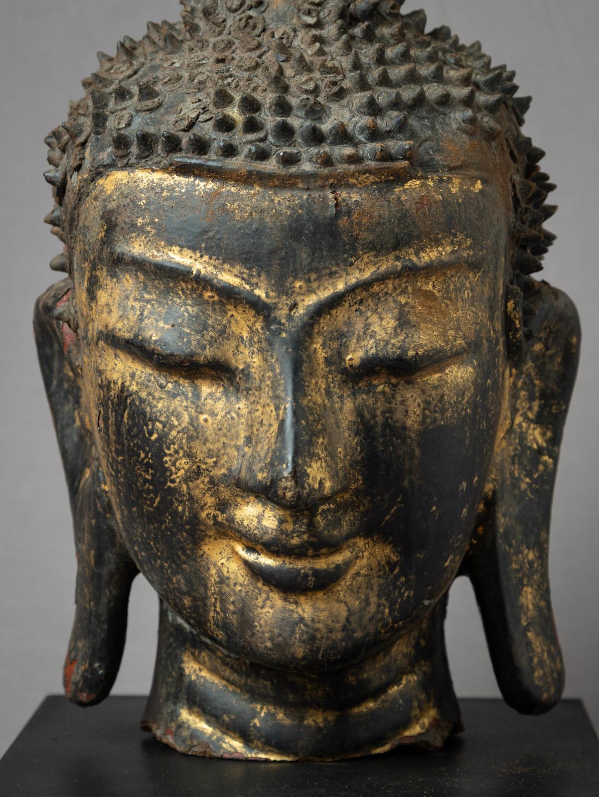 This Antique Burmese Buddha head, crafted from lacquerware, originates from Burma and belongs to the 18th century. It showcases the exquisite artistry of the Shan (Tai Yai) style. The Buddha head, measuring 48,5 cm in height, 24 cm in width, and 24