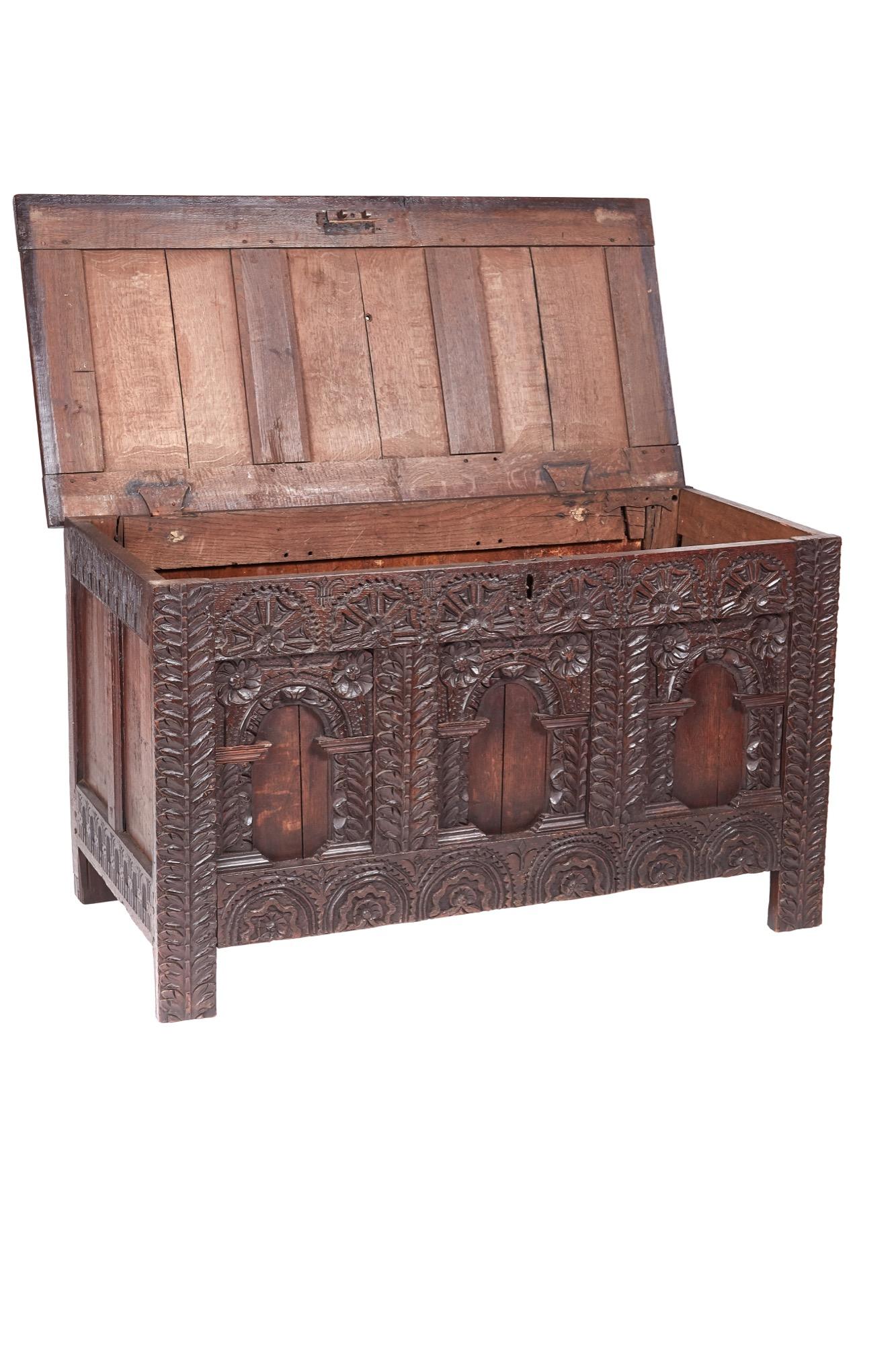 This is a fantastic 18th century antique carved oak paneled coffer with three panels to the top, intricately carved and beautifully designed frieze and panels to the front as well as paneled sides. It stands on stile feet.

In superior original