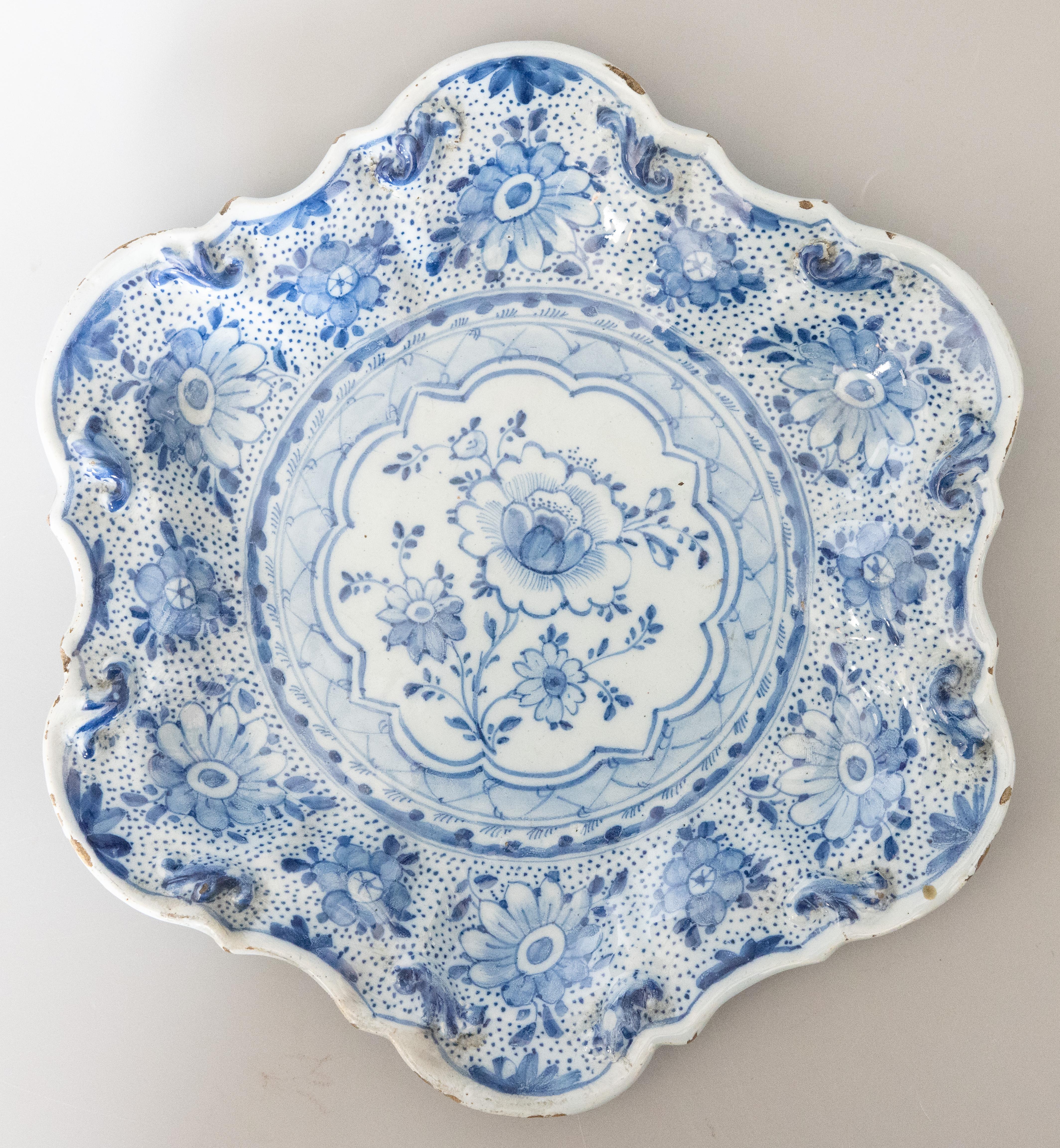 A wonderful pair of rare hexalobed Delft faience scalloped plates with floral decoration in cobalt blue. Marked under the base JVD, for Jan Van Briel.