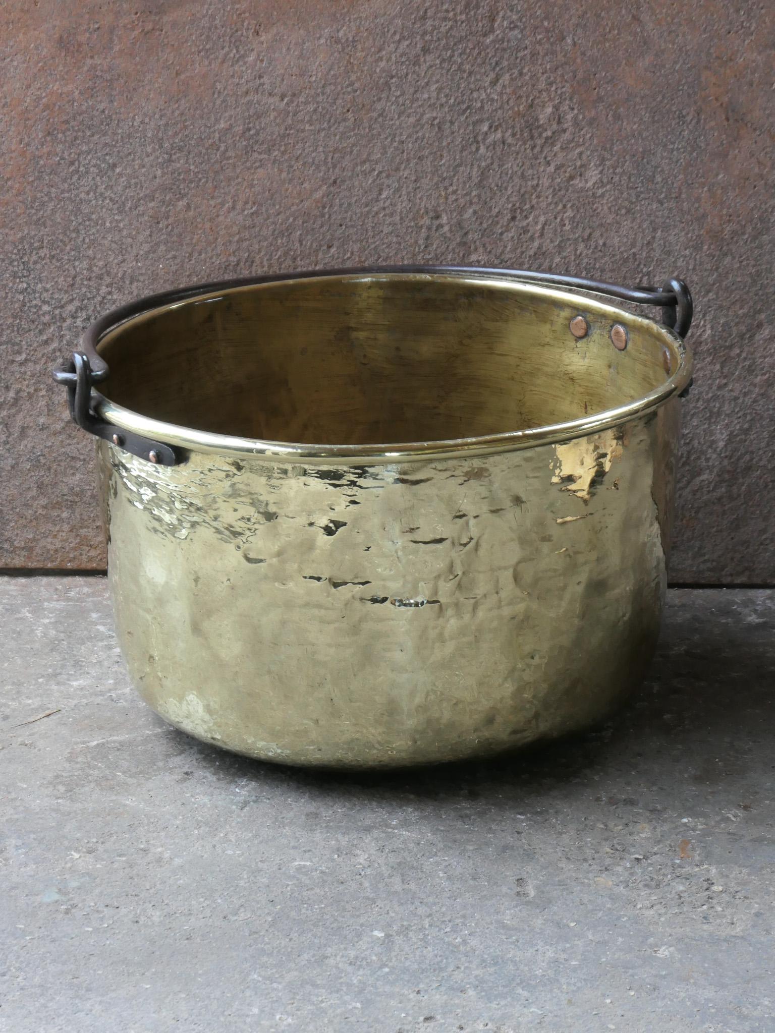 18th century Dutch log basket. The firewood basket is made of polished brass and has a wrought iron handle. Also called 'aker'. Used to draw water from the well and Cook over an open fire.

The log holder is in a good condition and is fully