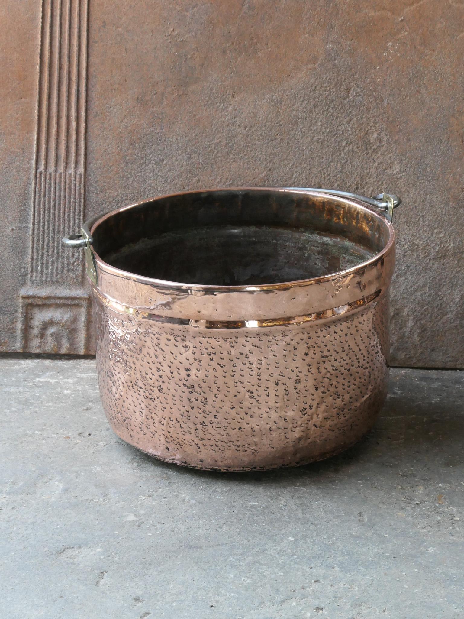 18th century Dutch log basket. The firewood basket is made of polished copper with brass details and has a wrought iron handle. Also called 'aker'. Used to draw water from the well and cook over an open fire.

The log holder is in a good condition