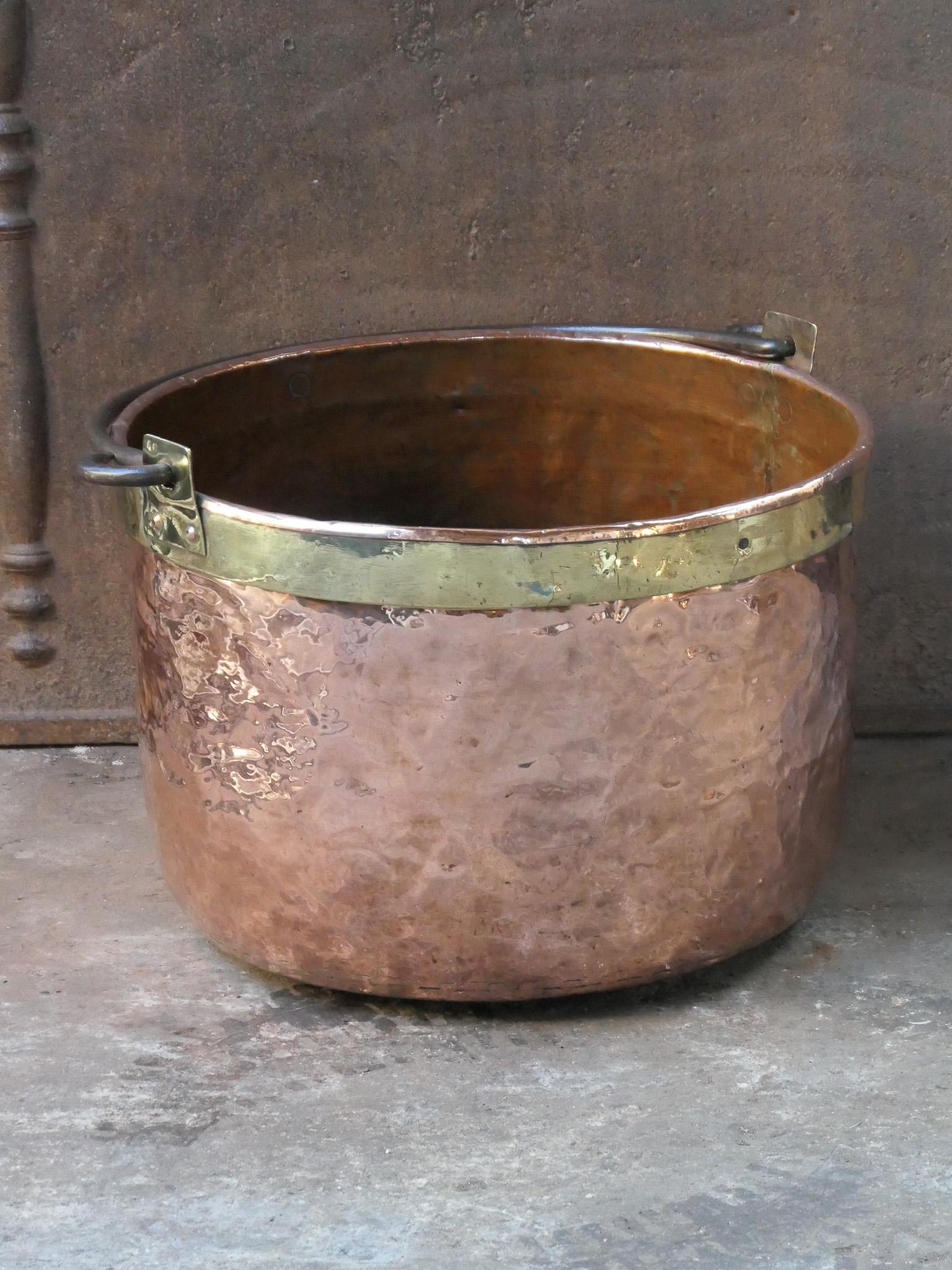 18th century Dutch log basket. The firewood basket is made of polished copper with polished brass and has a wrought iron handle. Also called 'aker'. Used to draw water from the well and cook over an open fire.

The log holder is in a good condition