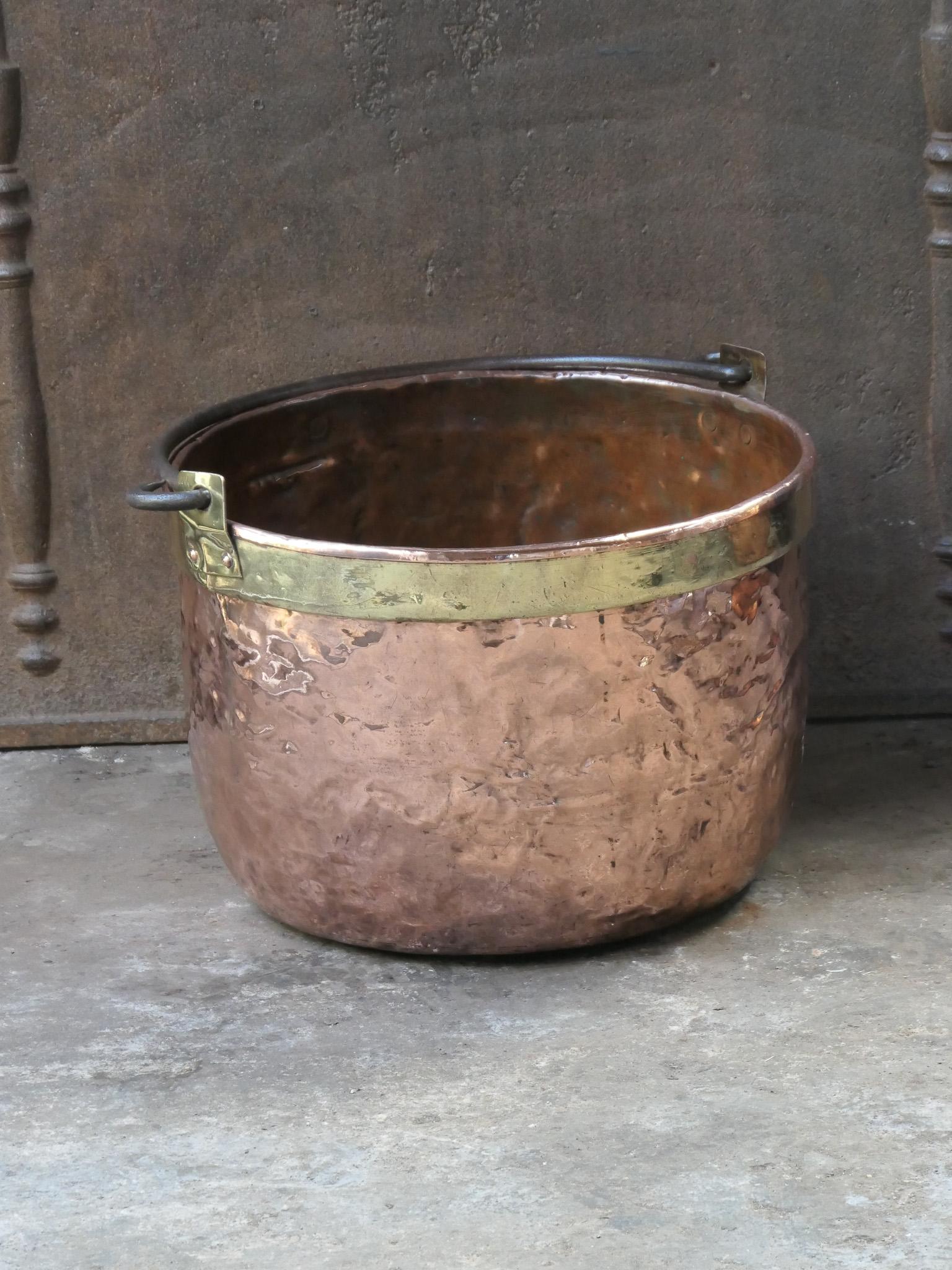 18th century Dutch log basket. The firewood basket is made of polished copper with polished brass and has a wrought iron handle. Also called 'aker'. Used to draw water from the well and cook over an open fire.

The log holder is in a good condition