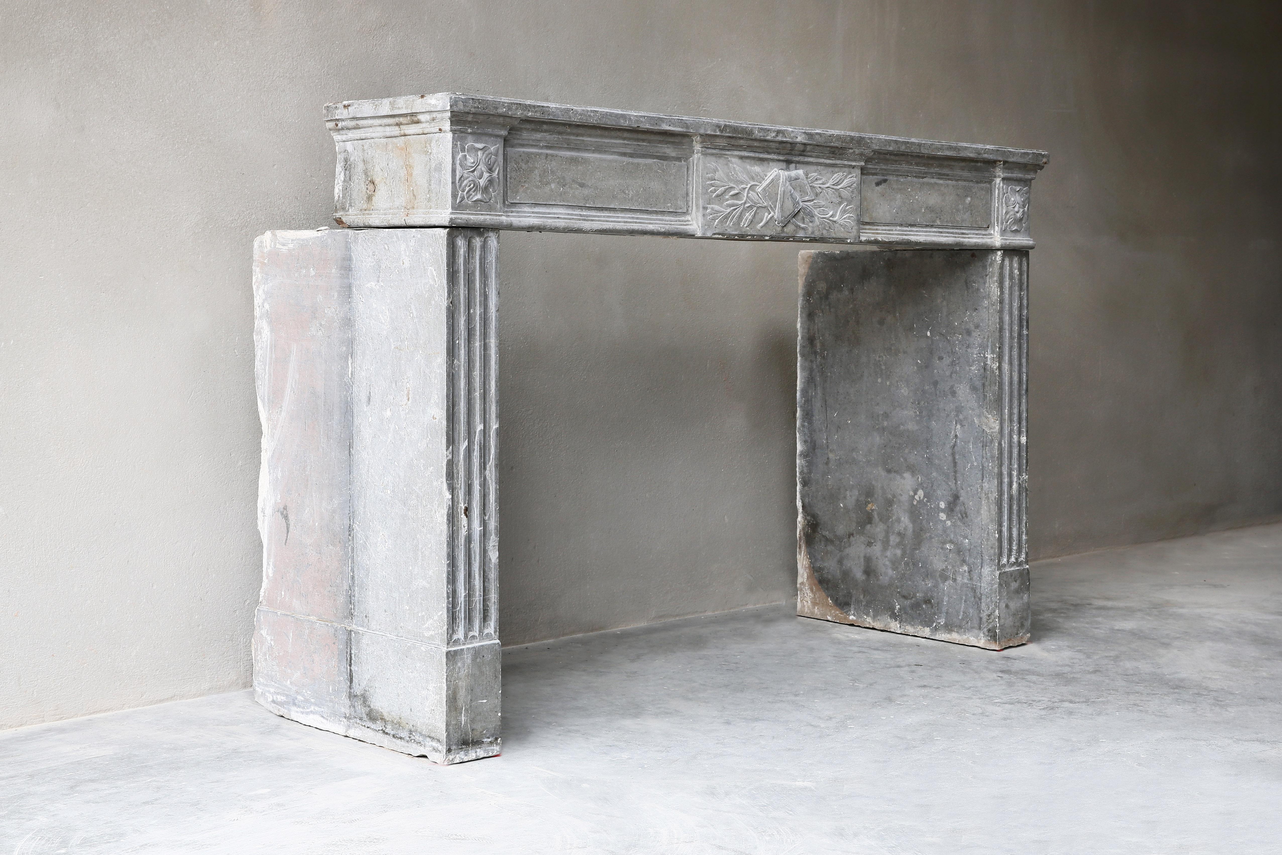Very exclusive antique fireplace made of gray marble stone! This fireplace has an authentic look due to the color scheme and shape. The fireplace dates from the 18th century and is in the style of Louis XVI. The front part has a beautiful ornament