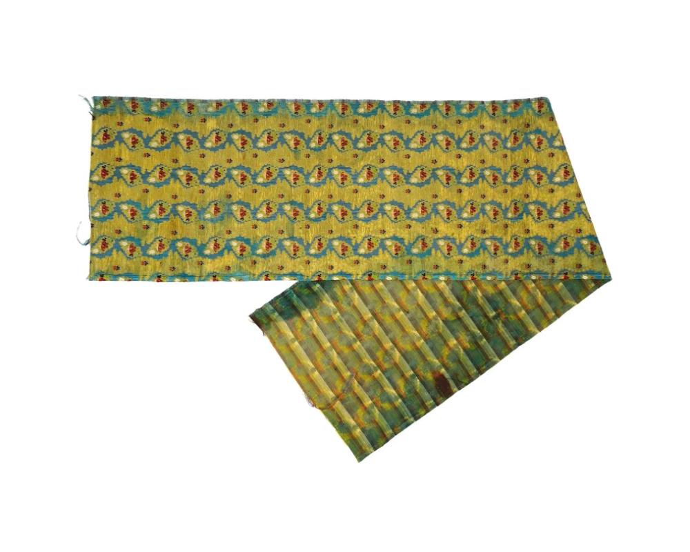 An antique French hand woven embroidered textile wall hanging or table runner. The ware is adorned with floral and foliage ornaments in bright green, red and blue shades. Circa: late 18th century. Antique and Vintage European Embroidered Woven