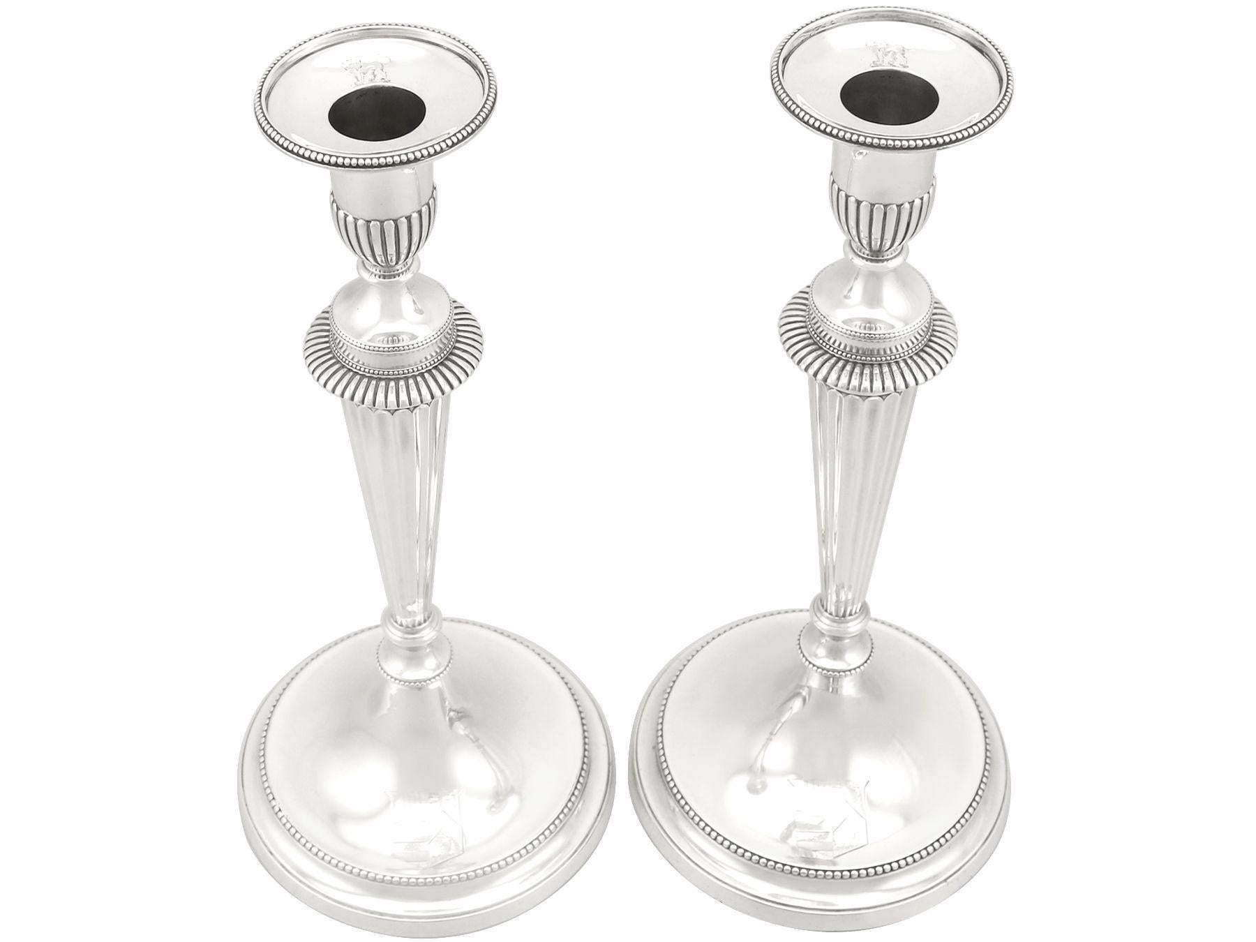 A magnificent, fine and impressive pair of antique George III English cast sterling silver candlesticks made by John Schofield; part of our Georgian ornamental silverware collection.

These magnificent antique George III English cast sterling