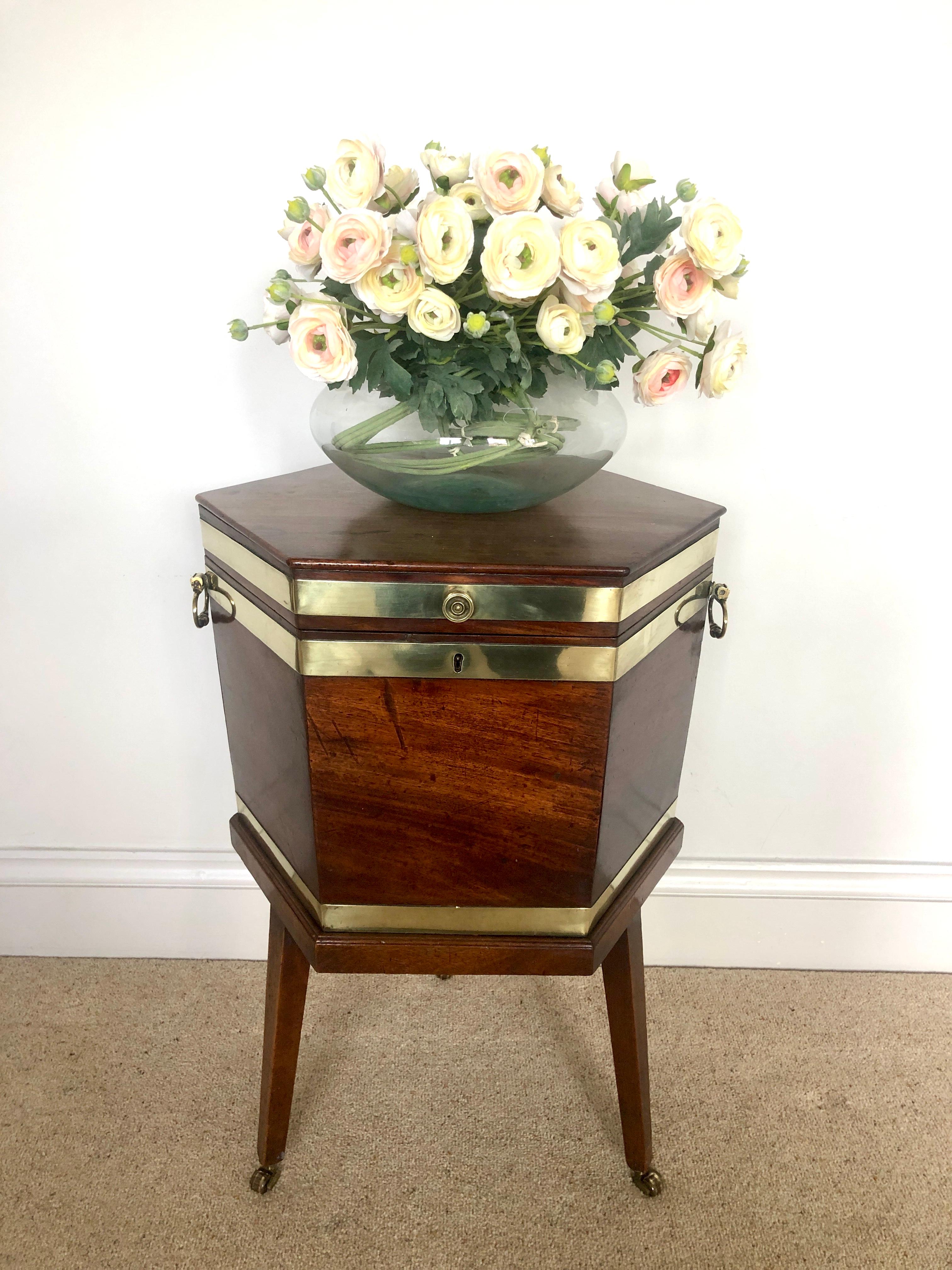 Fine antique George III mahogany brass bound wine cooler having the three original brass bands, two original carrying handles and original brass knob. The quality mahogany top lifts up to reveal the original lead lined interior raised on the
