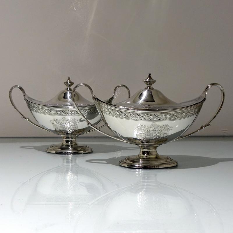 A stunning pair of 18th century boat shaped sauce tureens with detachable lids. The body of the tureens have a beautiful upper band of intricate bright cut engraving for highlights. The centre of both sides of the bodies have elegant contemporary