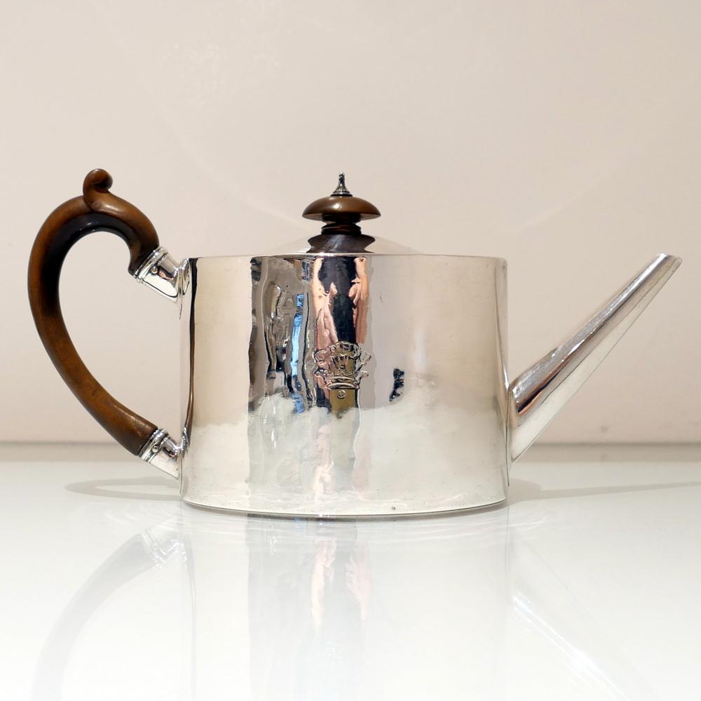 A beautiful plain formed 18th century oval flush hinged teapot with an applied fruitwood scroll handle. The centre front of the body has a contemporary crest for importance and the spout is the highly desirable “straight” formed.

 

Weight: