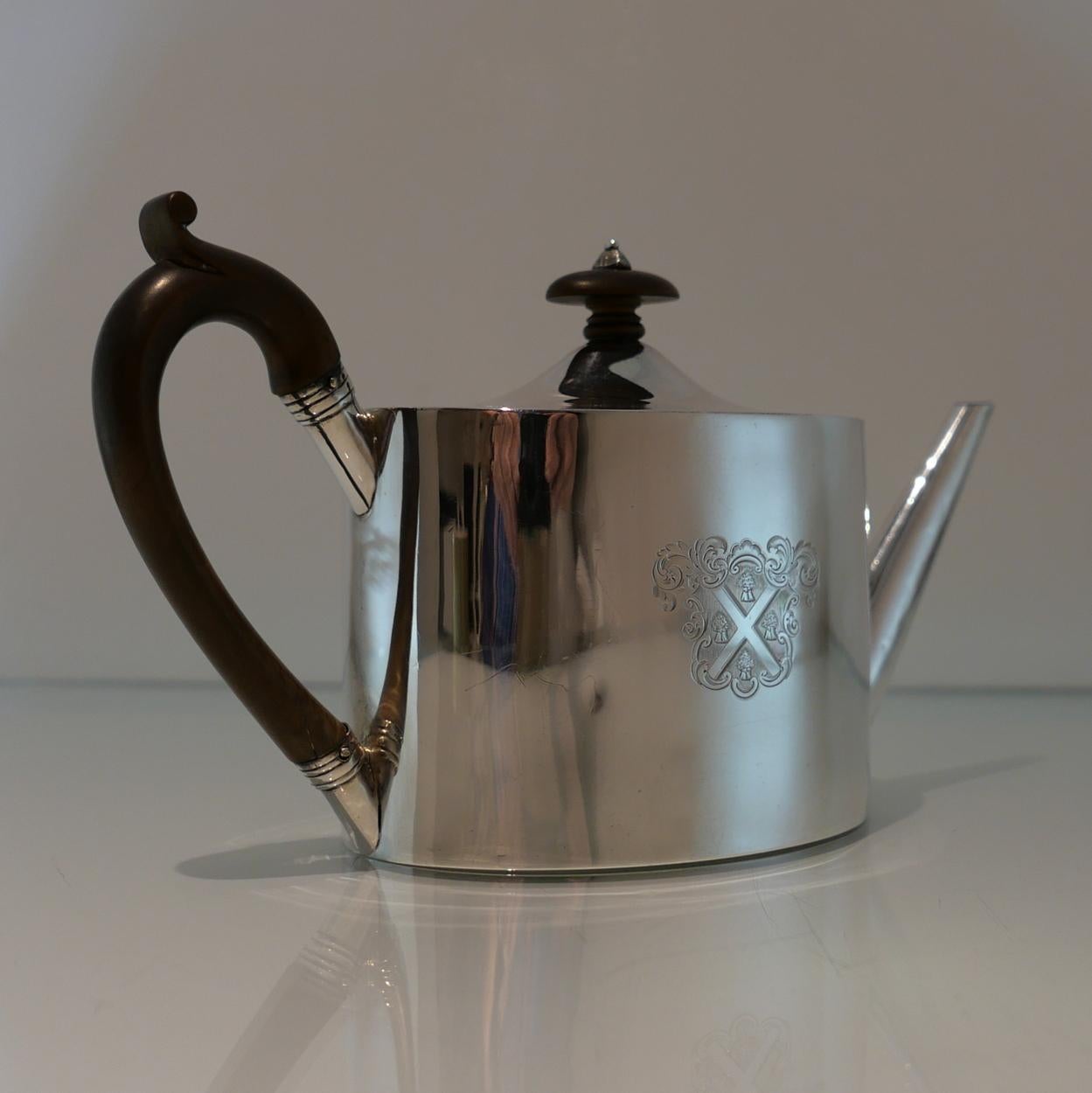 A stylish oval plain formed Georgian teapot designed with an elegant flush hinged and a stylish scroll formed fruitwood handle. Both sides of the body have contemporary armorial and crest for importance.

 

Weight: 14.5 troy ounces/453