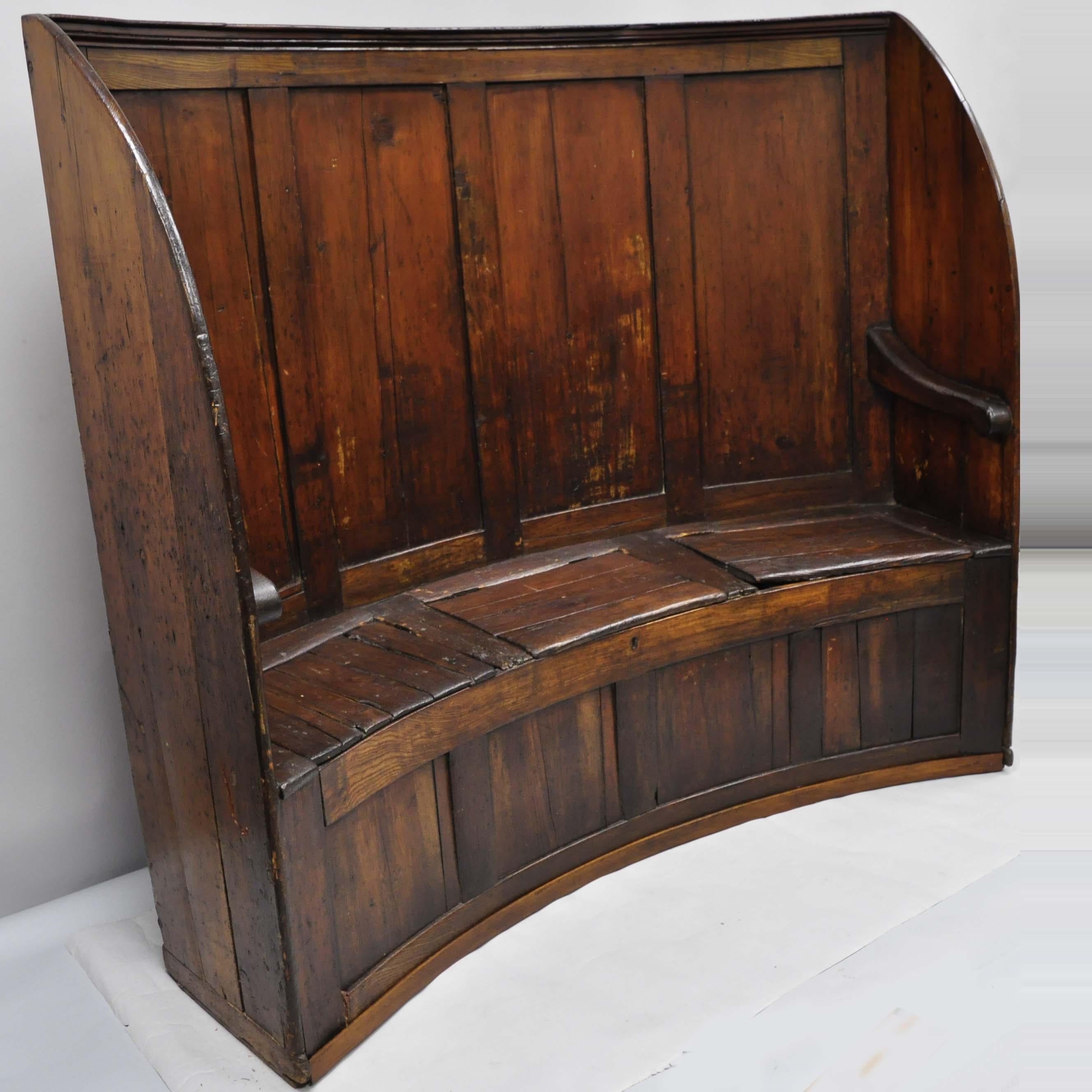 18th century antique high back curved English pine wood pub sette hall storage bench. Item features tall curved form, remarkable patina, 3 lift off storage seats, solid wood construction, beautiful woodgrain, nicely carved details, very nice antique