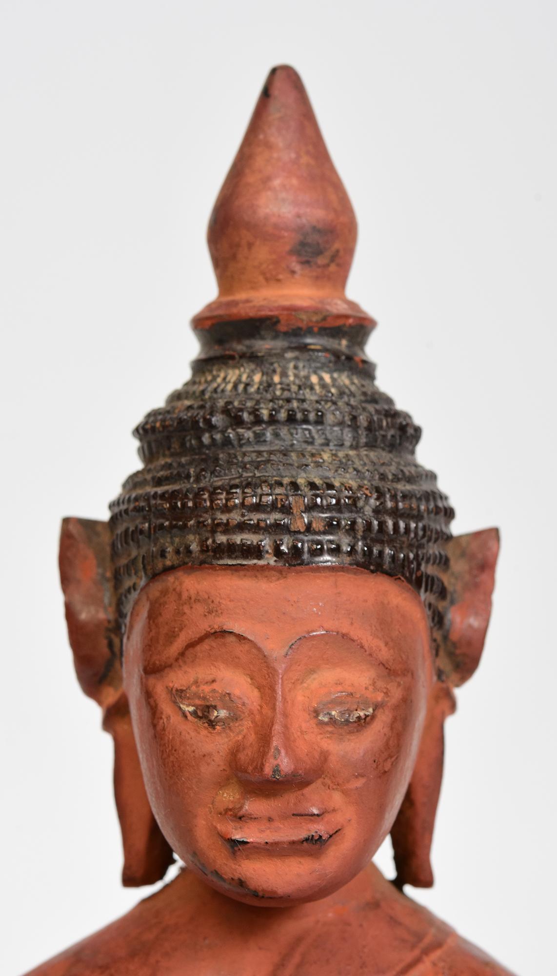 Khmer wooden Buddha sitting in Mara Vijaya (calling the earth to witness) posture on a base.

Age: Cambodia, 18th Century
Size: Height 25.2 C.M. / Width 9 C.M. / Depth 7.7 C.M.
Condition: Nice condition overall (some expected degradation due to its