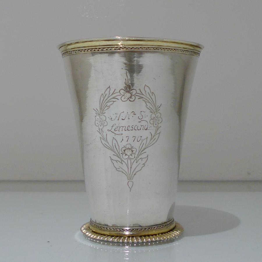 A beautifully designed large 18th century silver tapering formed beaker. The upper and lower sections have been gilded for decorative contrast and the inside has additional gilding. There is an engraved contemporary inscription and cartouche for