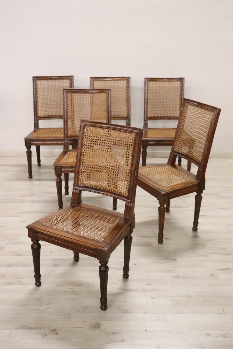 Very rare series of six antique dining room chairs production of Italy cabinetmakers, 1780. Featuring a linear backrest and solid spiked legs with a fluted pattern. Made of fine solid walnut wood. Of great value is the original Vienna straw on the