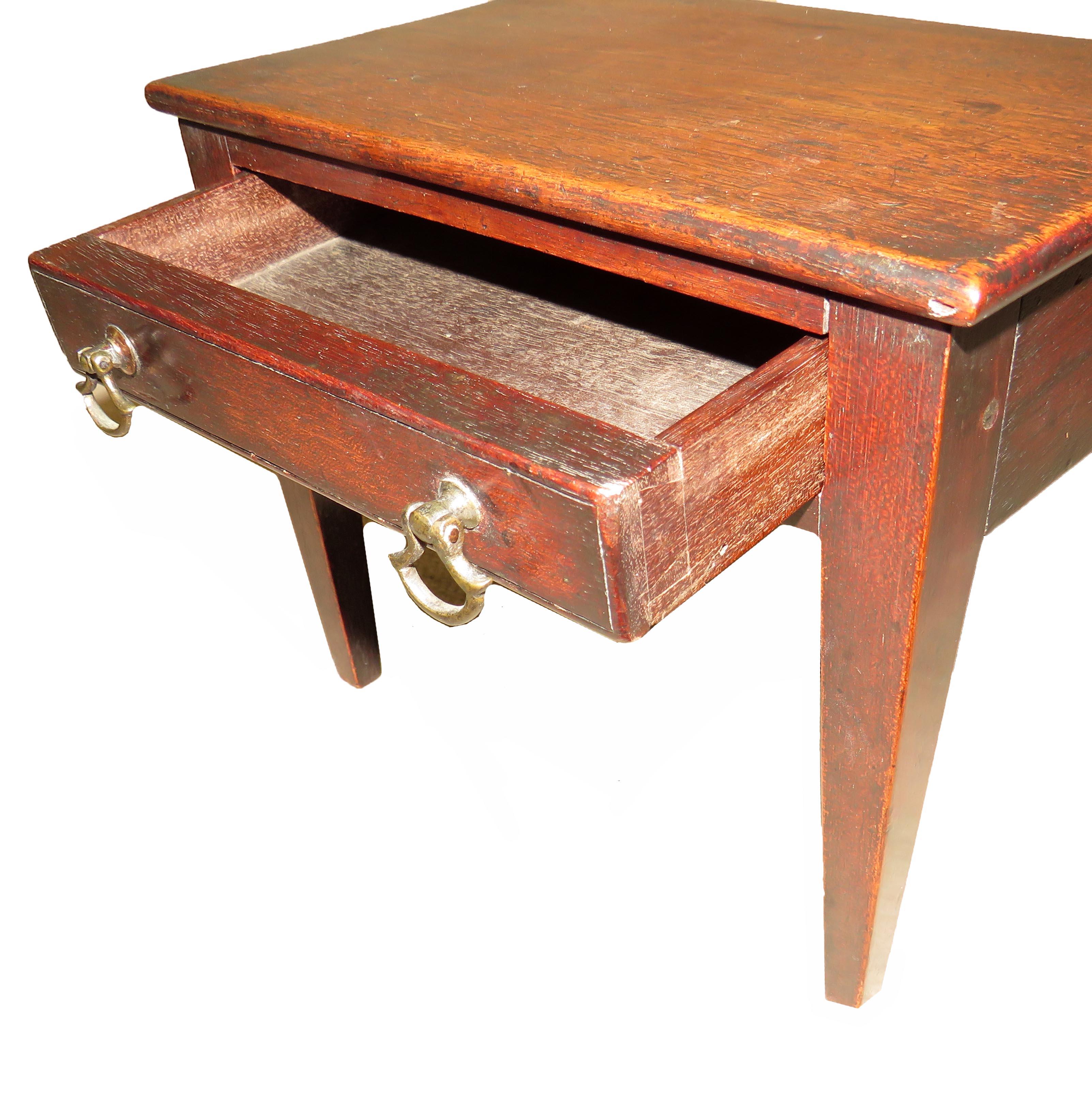 A charming late 18th century mahogany miniature side
Table having well figured top over one frieze drawer
With original brass handles raised on elegant square
Tapering legs

(There is often a debate over whether miniature furniture was made